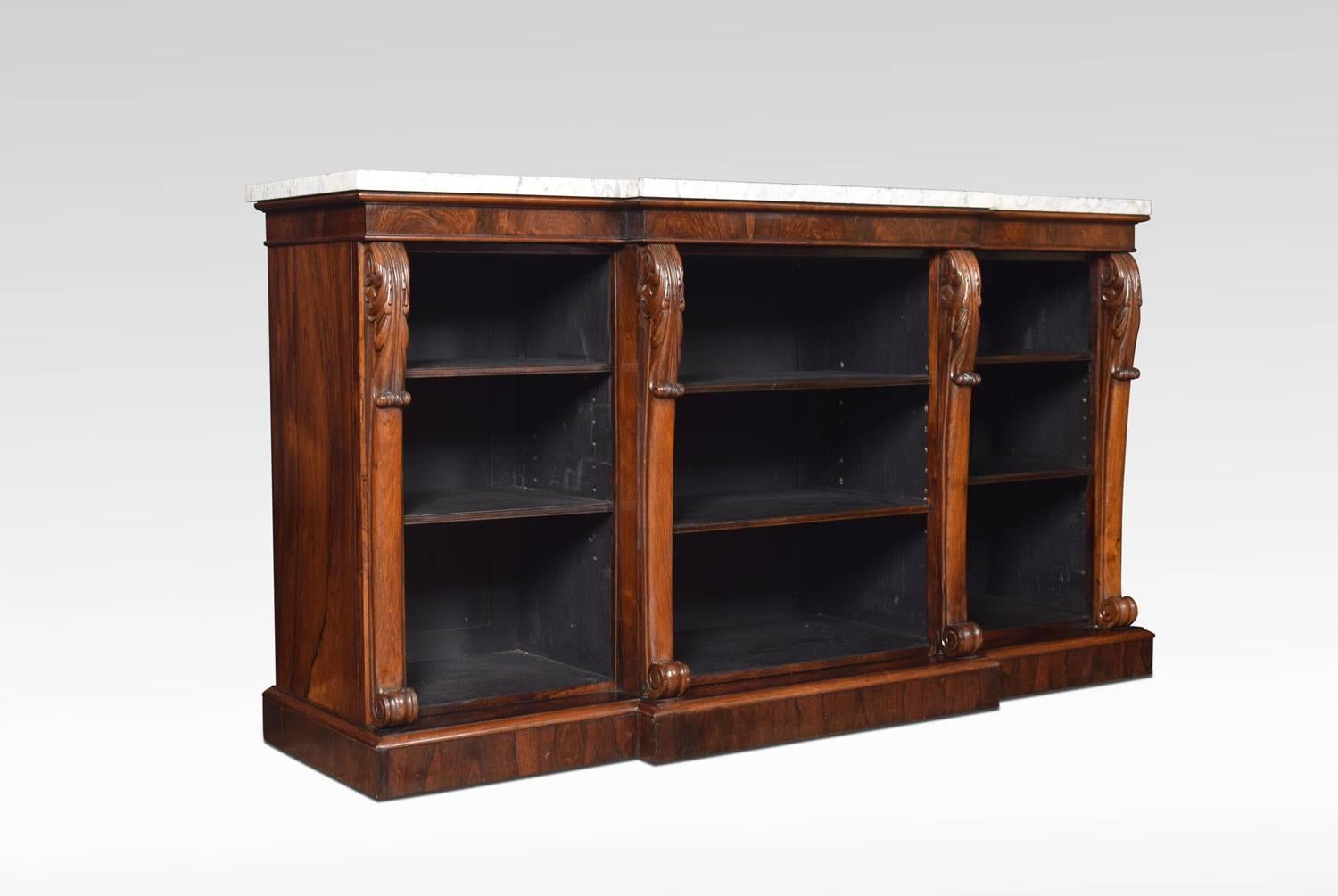 Regency rosewood open bookcase, the large rectangular breakfront white veined marble top above three bays of adjustable shelves flanked by carved scrolling columns. All raised up on plinth base.
Dimensions:
Height 37.5 inches
Width 67