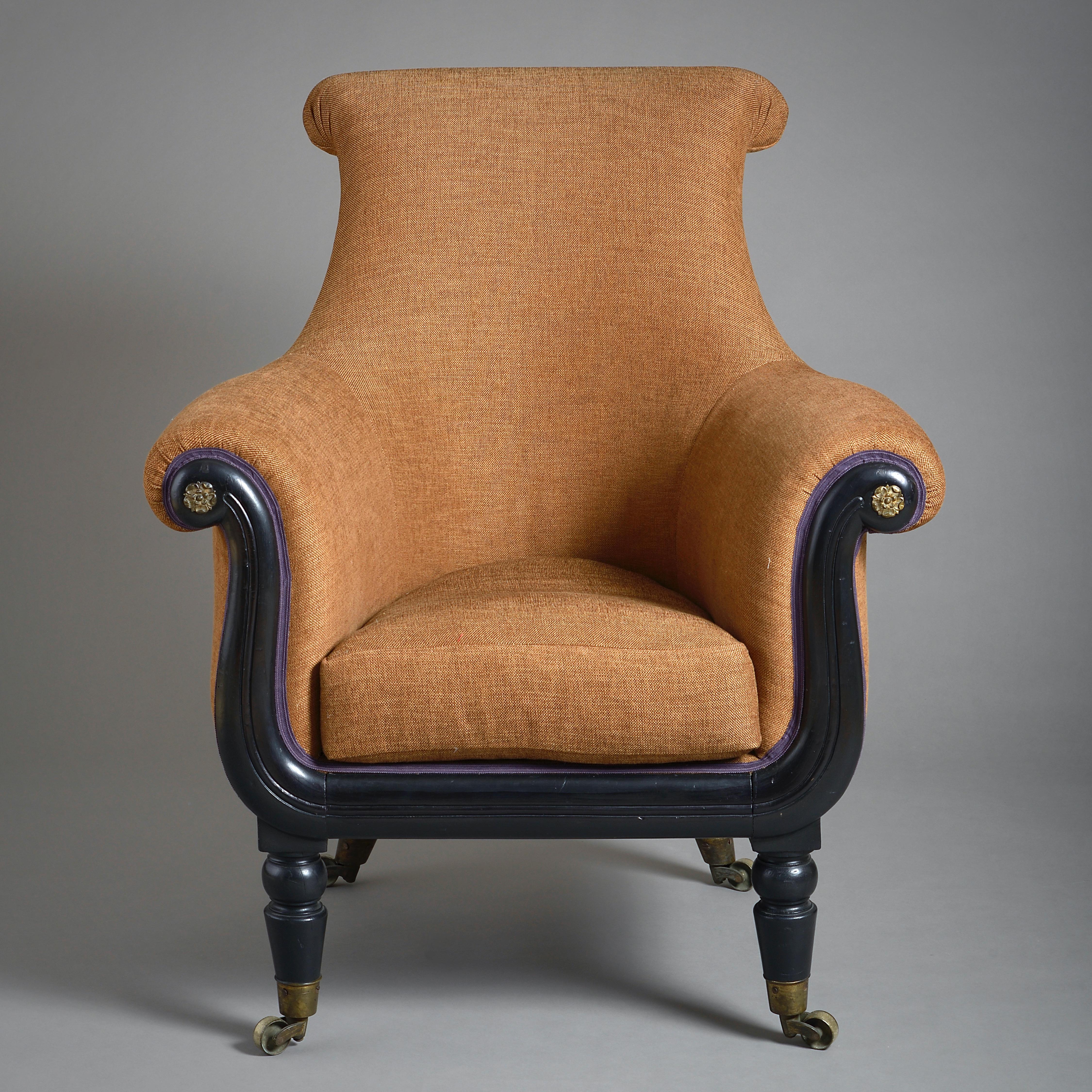 A LATE REGENCY EBONISED LIBRARY ARMCHAIR, CIRCA 1820.

Original brass socket castors.