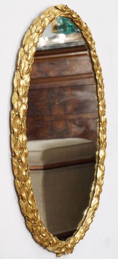 Regency Era Carved Giltwood Oval Mirror with Laurel Leaf Design from England