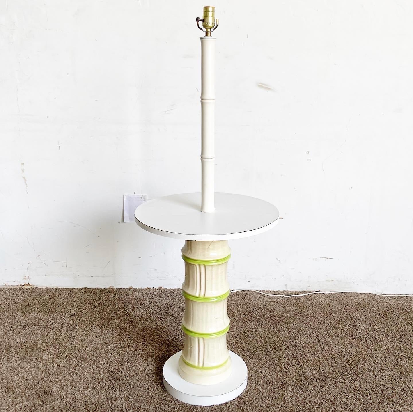 Discover the Regency Faux Bamboo Lamp/Table Combo, a versatile piece that serves as both a floor lamp and a side table. With its ceramic stem and faux bamboo wood details, this item combines classic elegance with utility, fitting perfectly in both