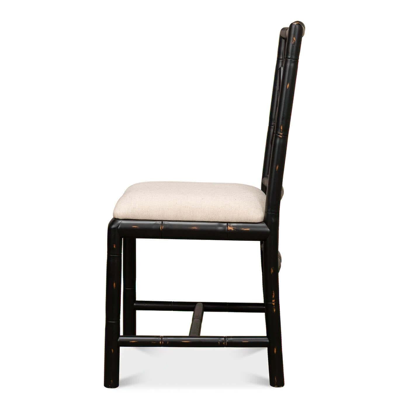 A Regency-style faux bamboo side chair. This hand-carved chair with a faux bamboo motif is inspired by designs of the Brighton Pavillion. It is shown in our black rubbed finish and a linen seat. 

Dimensions: 17