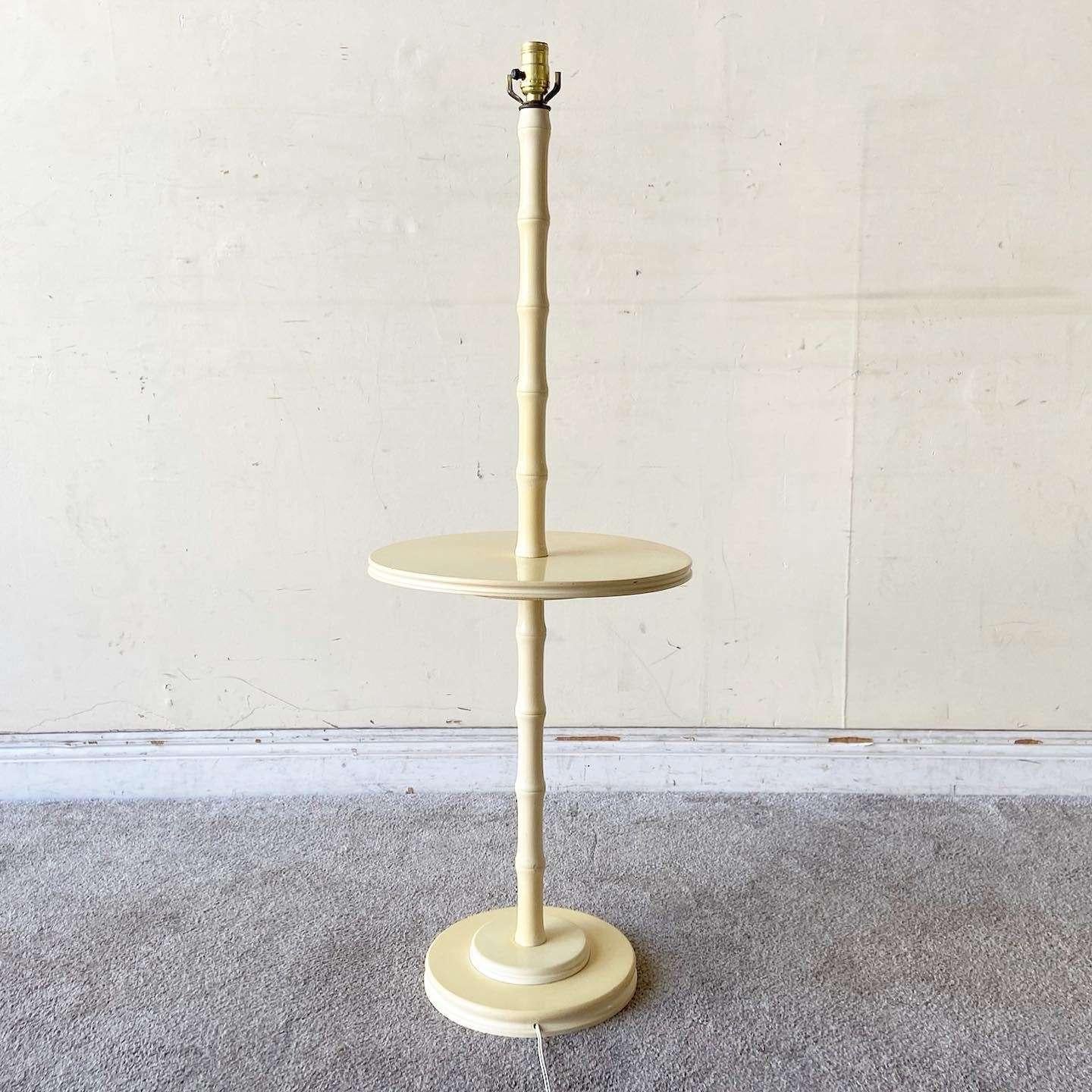 Exceptional vintage boho chic costal regency side table/floor lamp. Features a cream finish with a faux bamboo stem.

