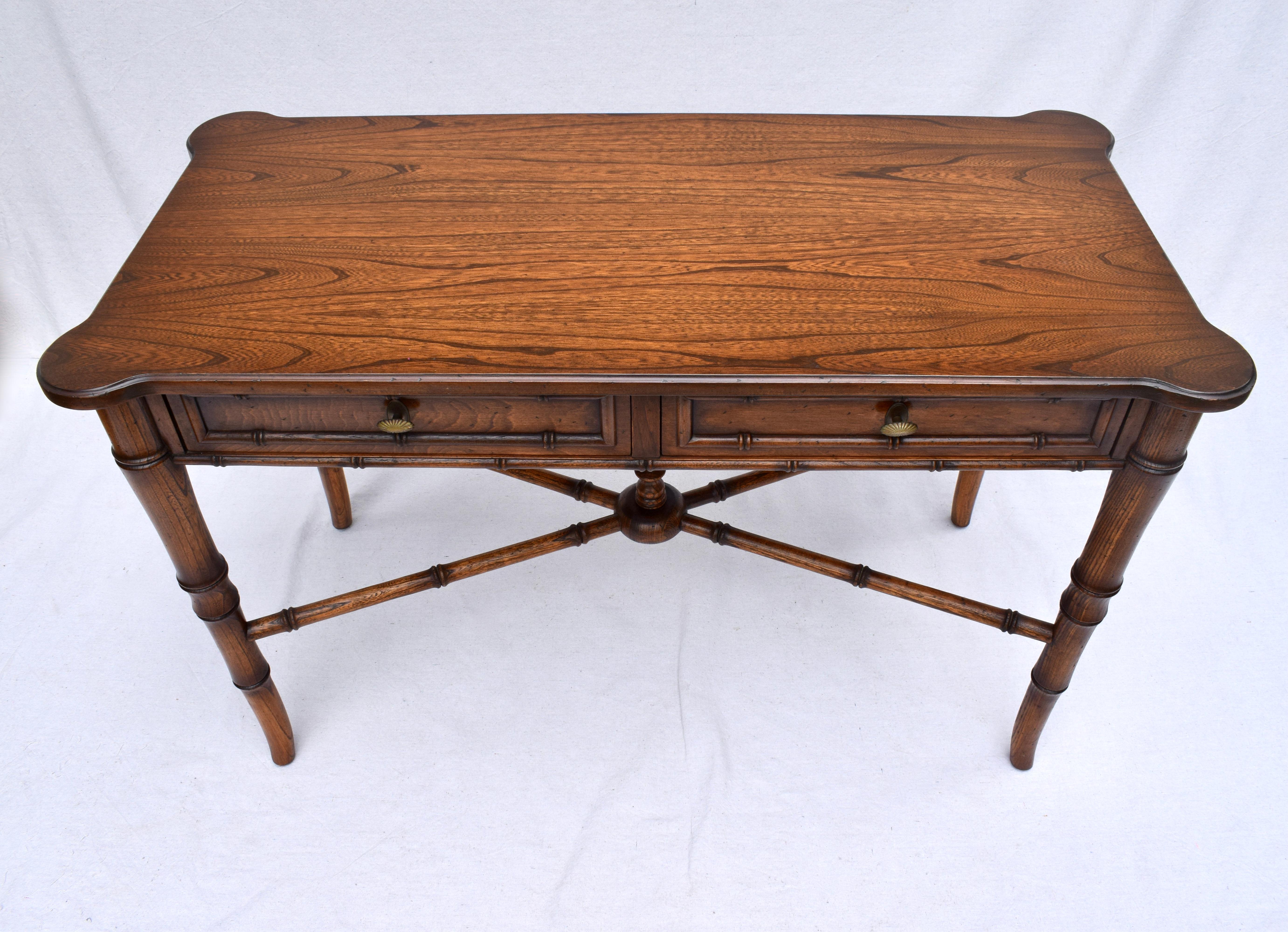 Exquisite two dovetailed drawer Regency style faux bamboo solid Oak writing desk with X stretcher base & finial. Early 20th c. attributed to Baker Furniture. Heirloom quality in pristine condition.