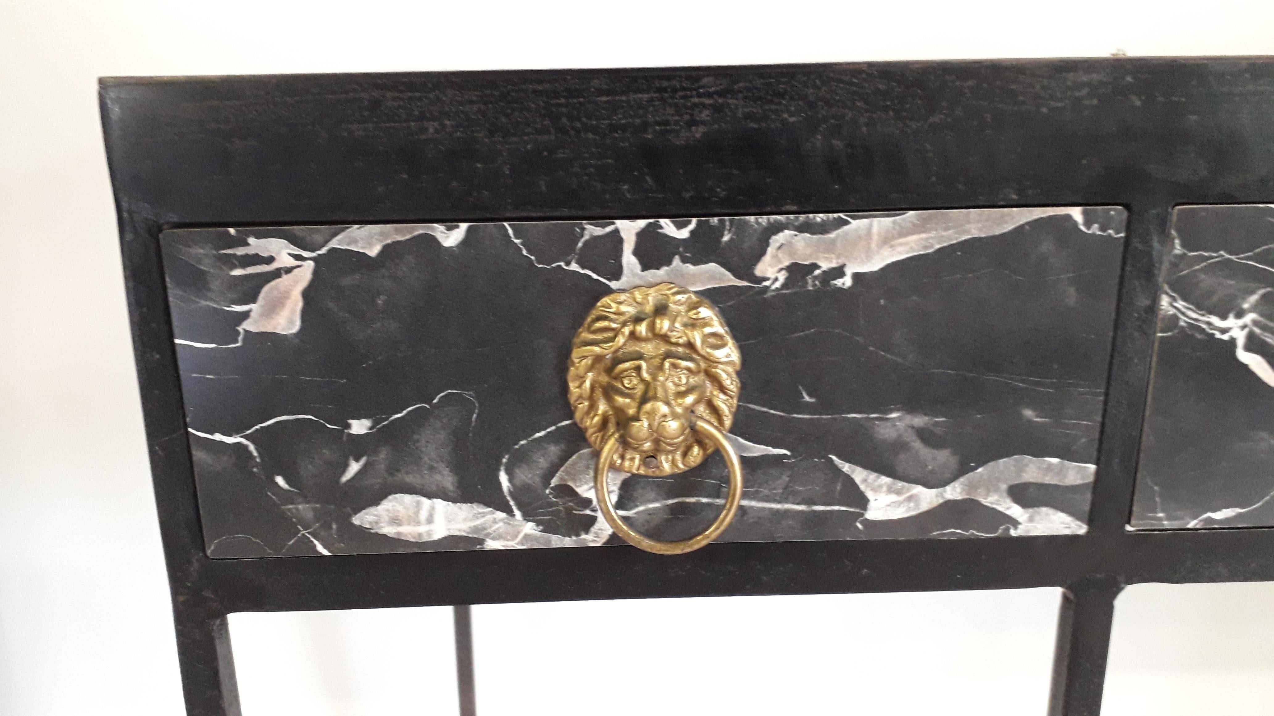 This one piece 1960's sideboard is constructed from forged metalwork and incorporates faux marble panels, the ironwork is mounted with bronzed iron mask heads

68