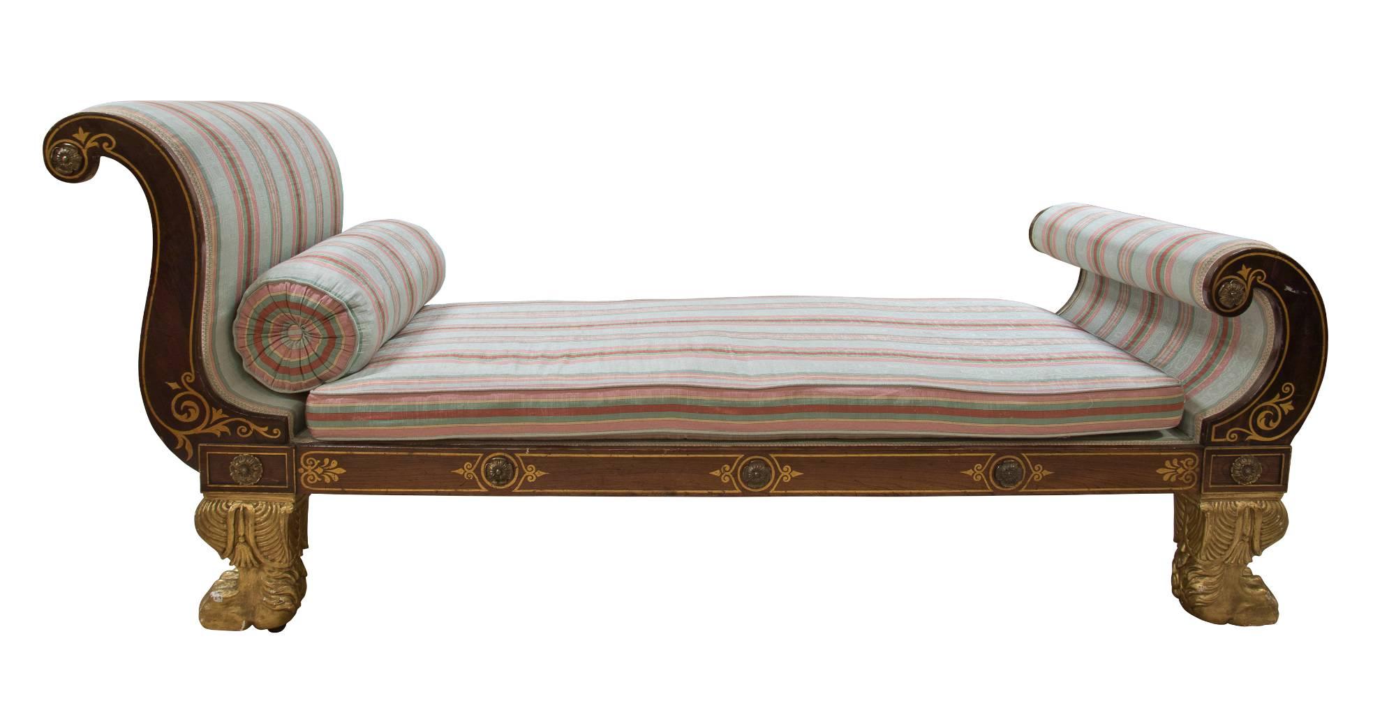 A Regency faux rosewood and ormolu-mounted, brass inlaid chaise lounge with gilded paw feet,


circa 1805.
 