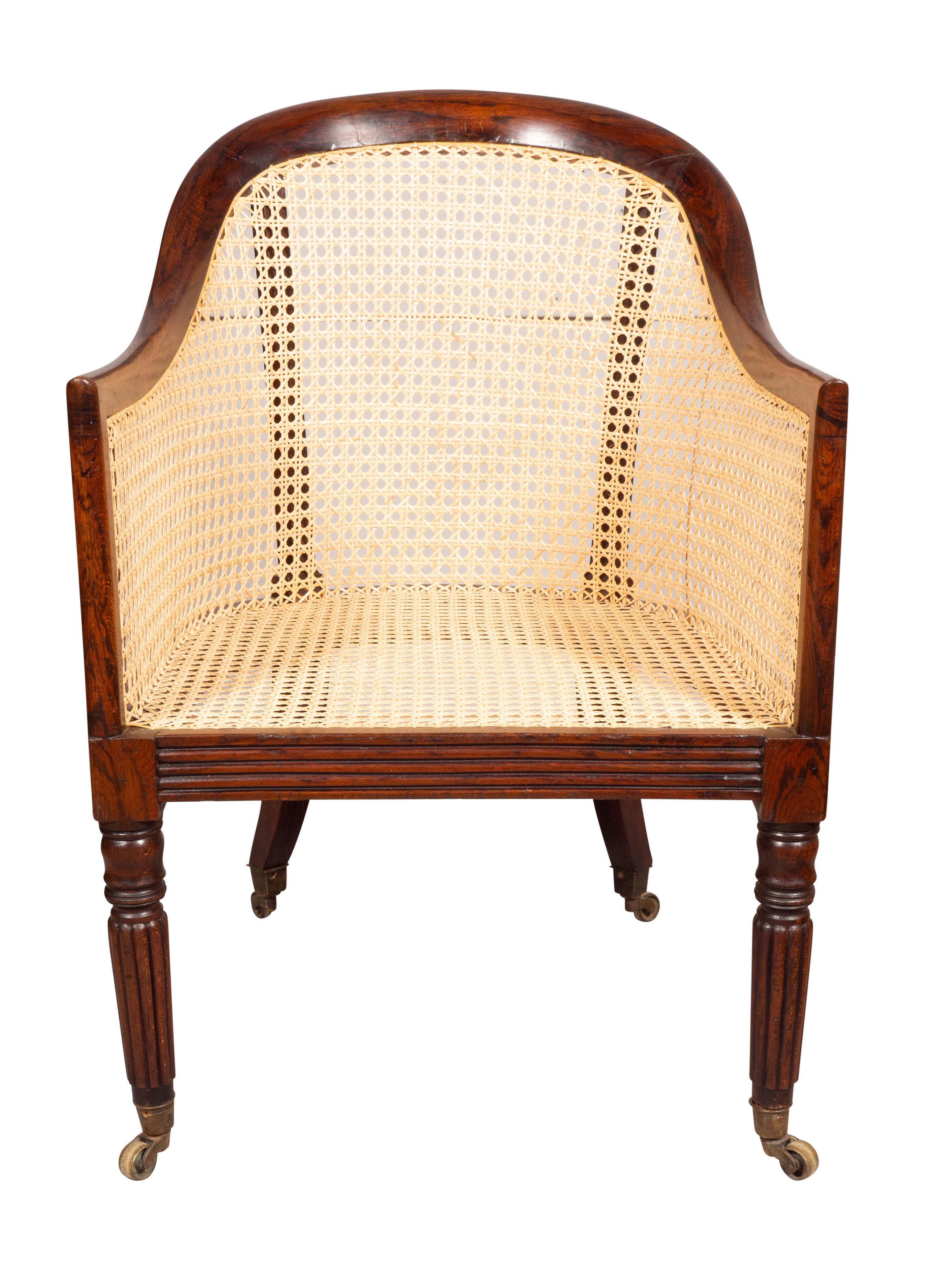 With an arched back. Completely newly hand caned. Reeded chair rail. Raised on circular tapered reeded legs. Casters.