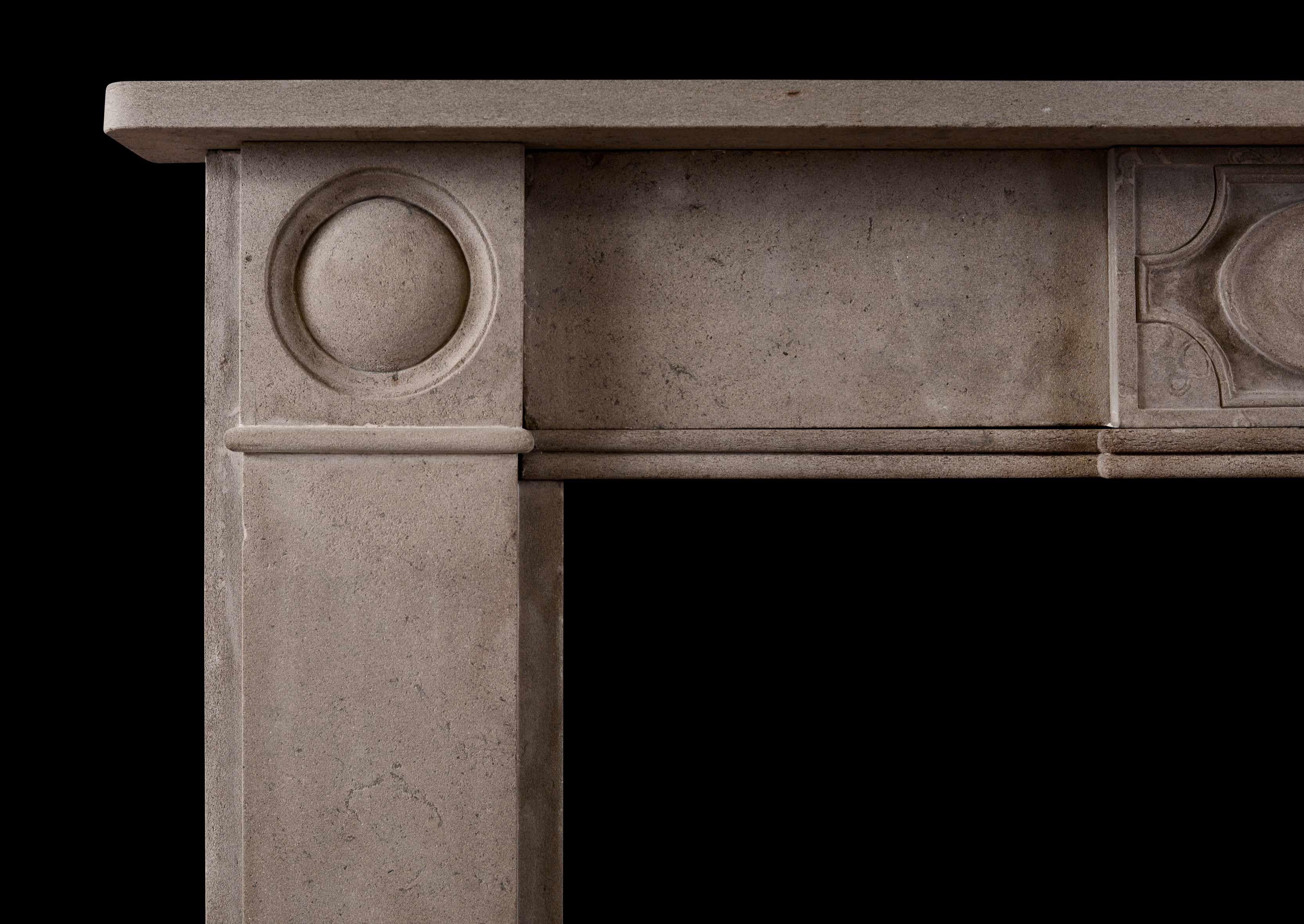 A Regency style antique fireplace in Purbeck stone. The flat jambs surmounted by roundel paterae, the frieze with carved centre block. Plain shelf above, English, 19th century.

Measures: Shelf width - 1334 mm 52 ½ in
Overall height 1162 mm 45 ¾