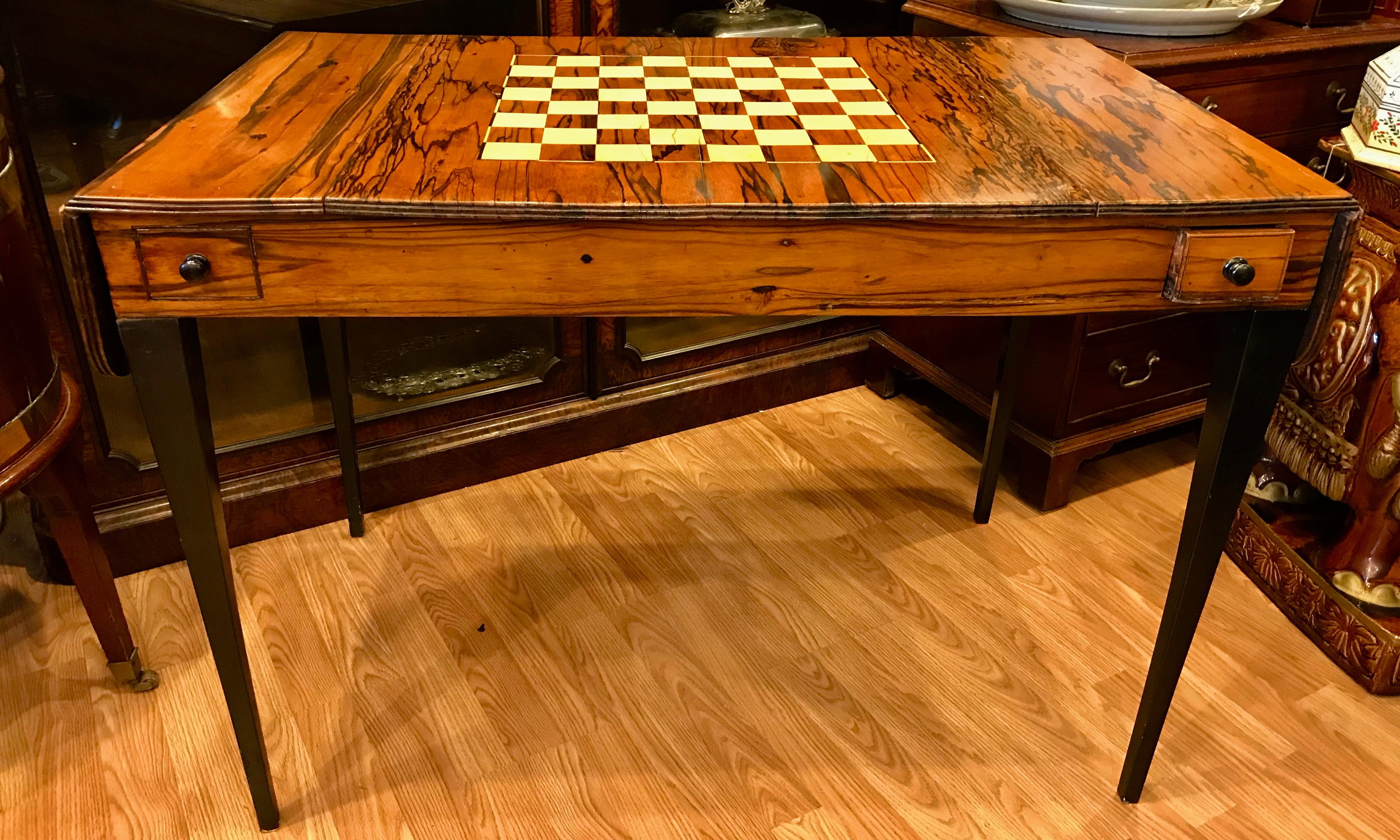 An exquisite 19th century calamander veneered English game table.
Refined style with a reversible slide out top. The legs and handles
are ebonized. The table is measured closed. The leaves are 6