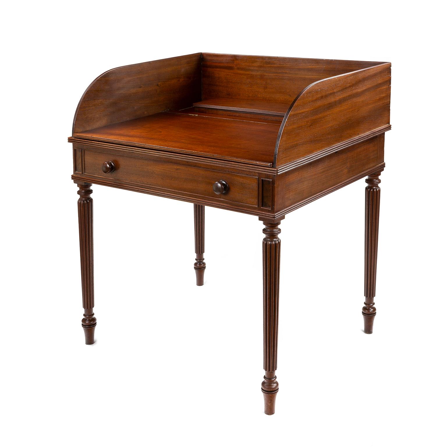 A Regency mahogany wash stand / writing table by Gillows of Lancaster and London. These tables where designed to work in two ways, one as a wash stand and also as a writing table, they have a built in pen tray, ink pot and blotter