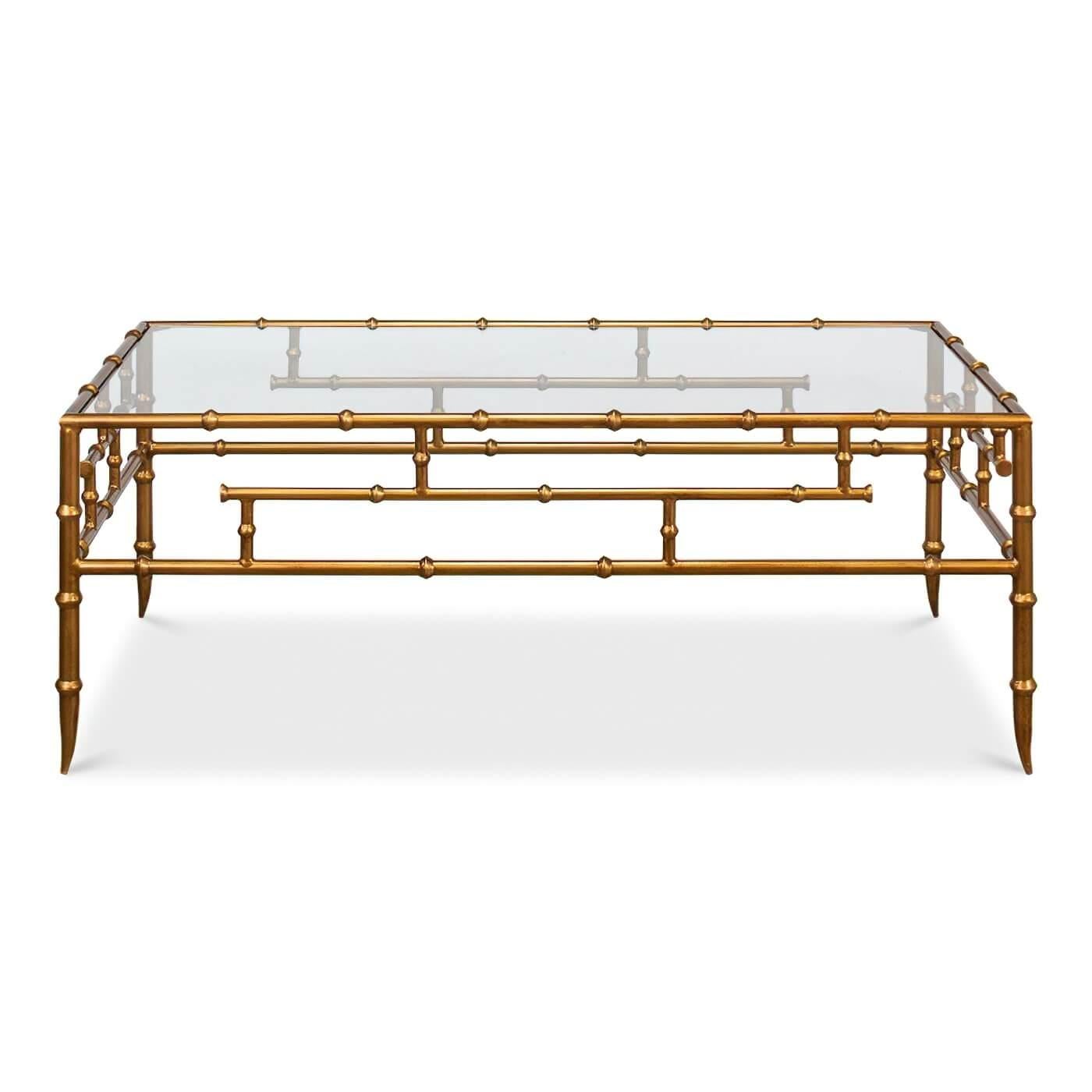 A Regency gilt bamboo coffee table. A classic and traditional piece with a glass top and elegant gold faux bamboo legs. 

Dimensions: 48