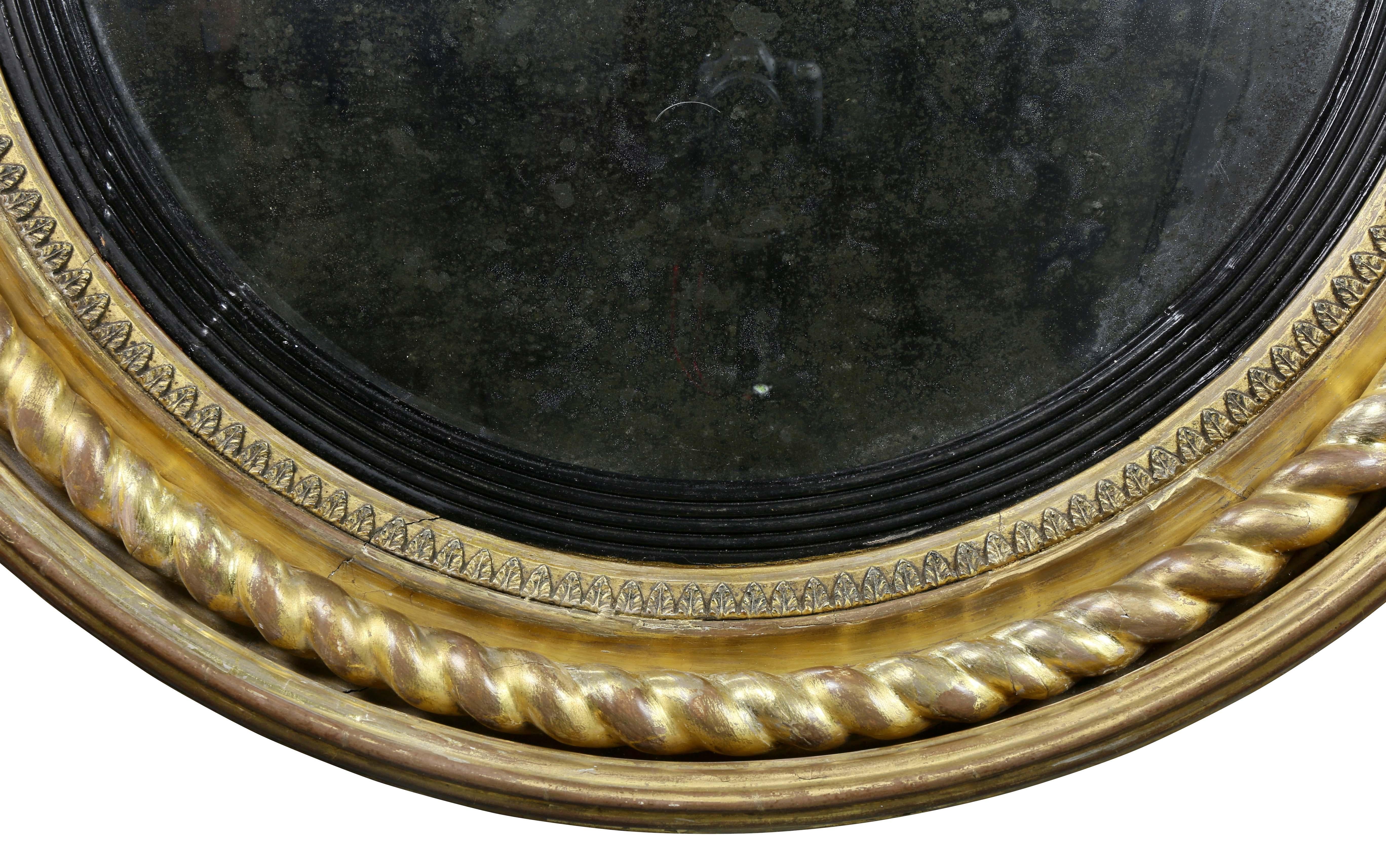 Circular with rope twist and leaf tip decoration, ebonized inner band, old glass.