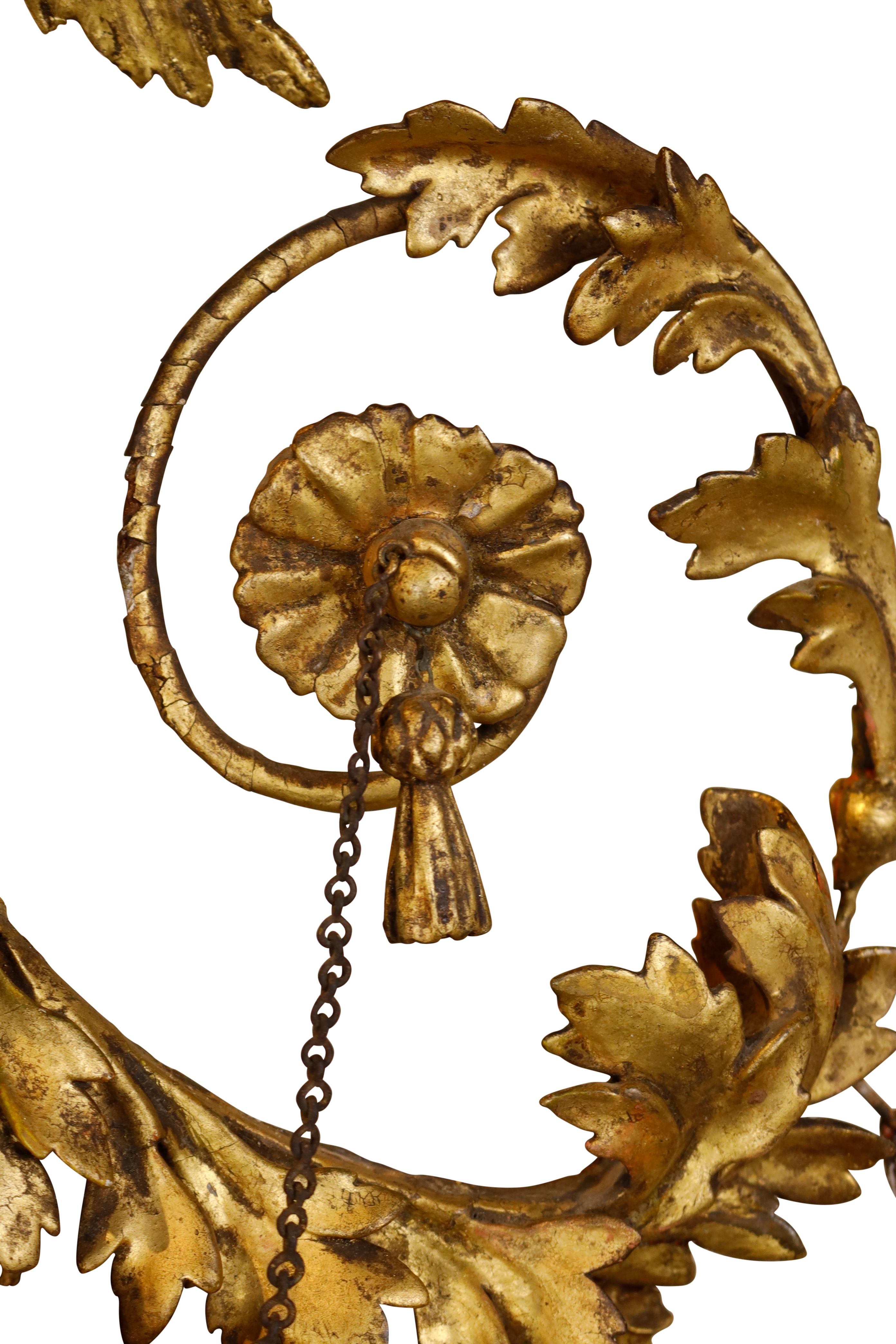 Regency gilt convex mirror with surmounted eagle flanked by cascading leaves and rosettes with delicate chains ending with a tassel.  Original mirror plate.