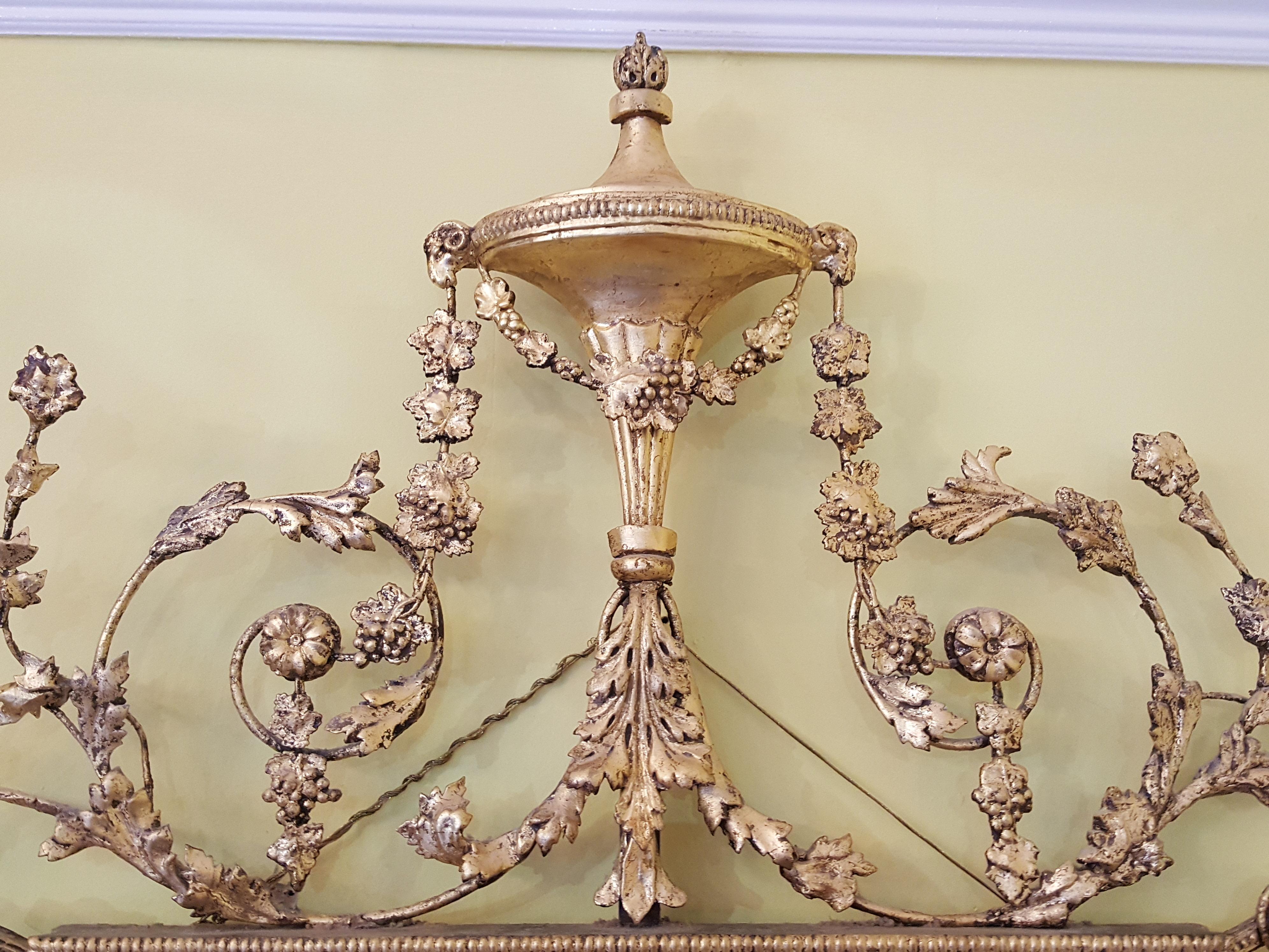 Regency giltwood mirror with swags and urn finial and floral pediment decoration.
Measures: 32