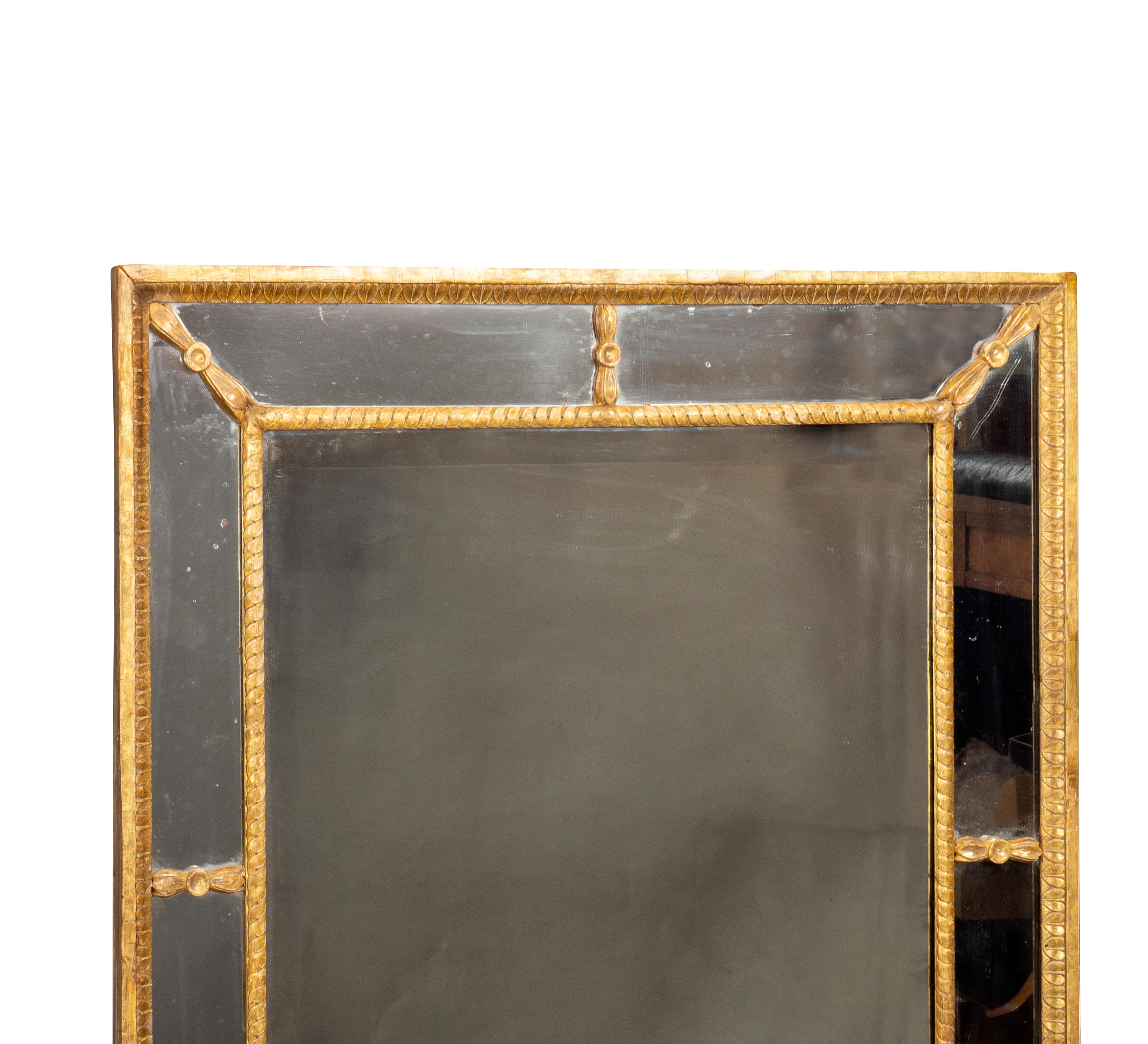 Leaf tip and guilloche carved burnished 23 ct gold leaf frame with outer mirrored frame and inner beveled mirror plate.
Provenance: Hyde Park Antiques.