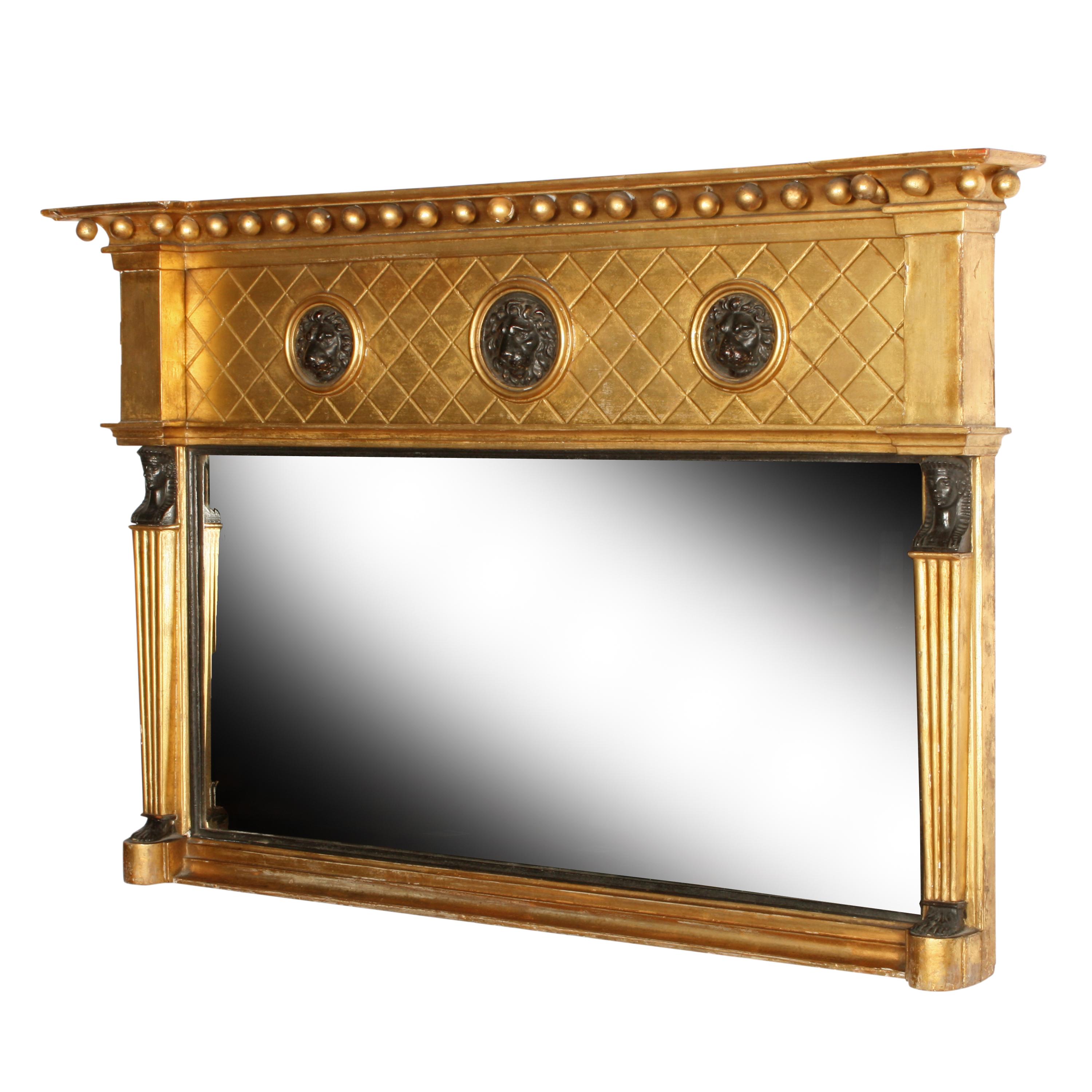 Regency giltwood overmantel mirror.


An early 19th century Regency carved gilt wood and gesso overmantel mirror.

The frame is decorated with three lion masks in the top frieze and Egyptian figures flanking the mirror plate.

The mirror has