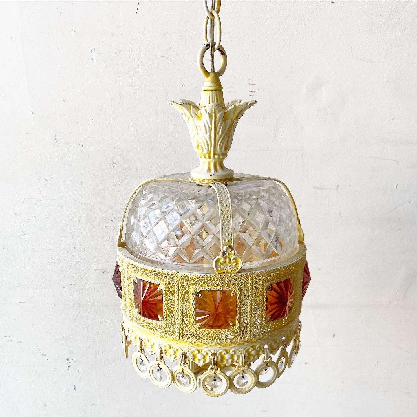 Amazing vintage regency pendant/swag lamp. Features a cream finish over the metal with orange glass square and “Crystal” accents.