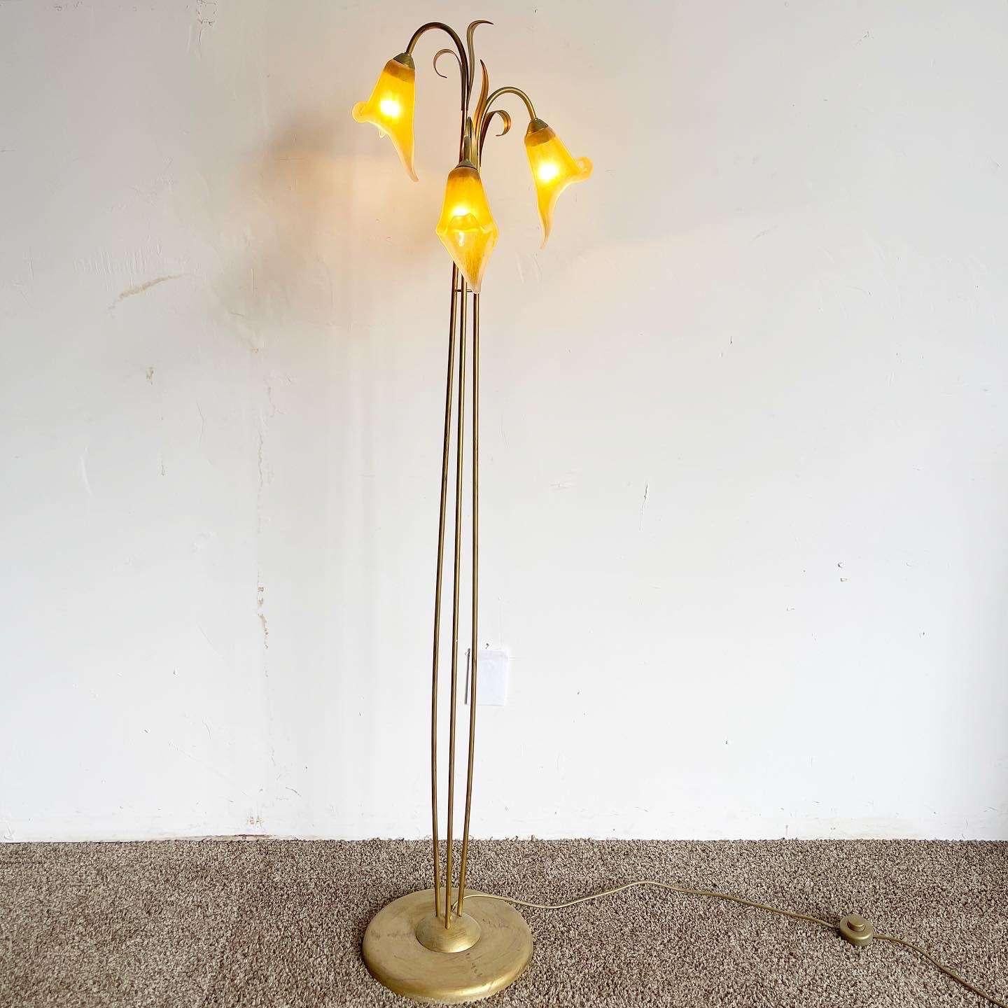 Incredible vintage regency metal and glass floor lamp. Features three glass tulip lamp shades on three gold stems.