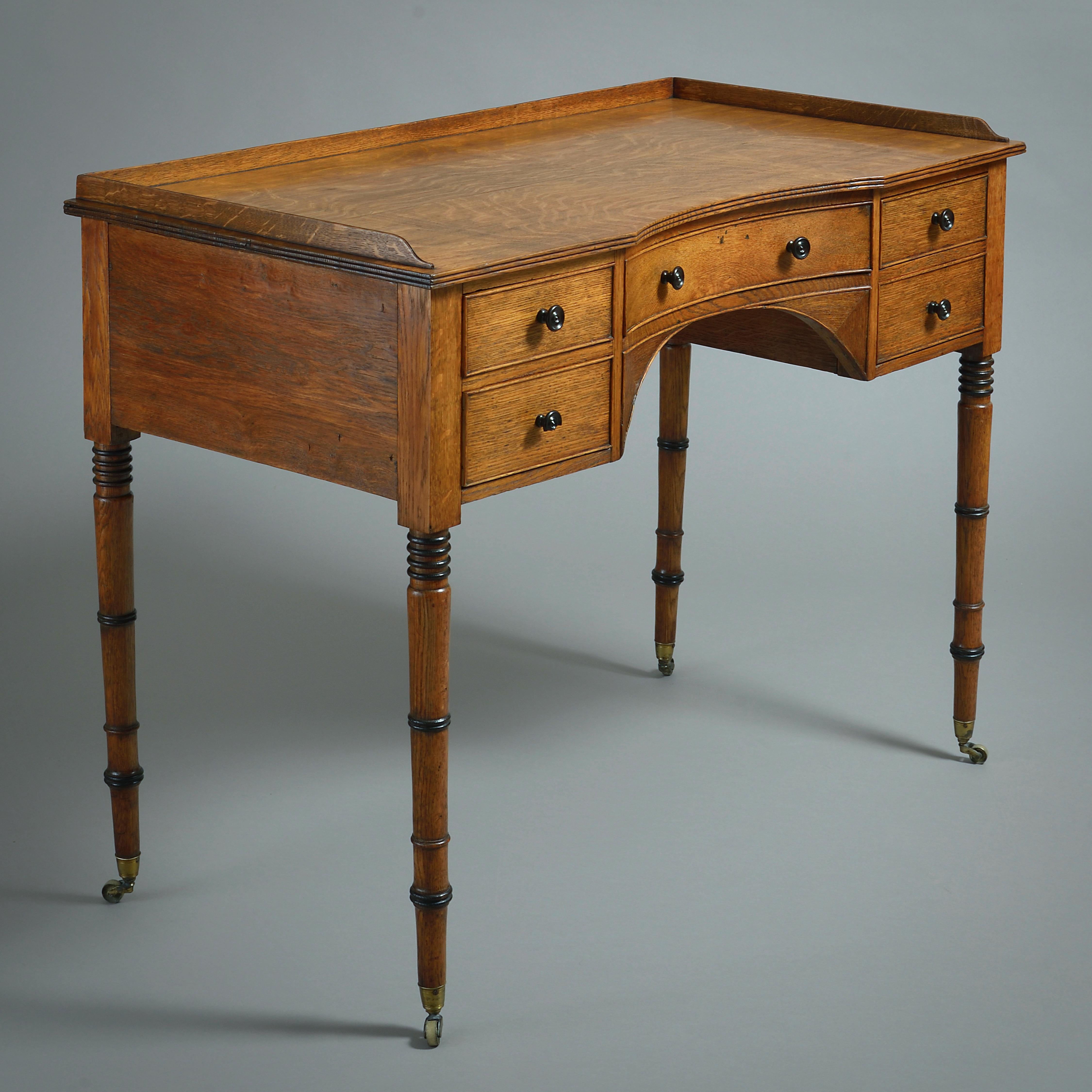 A REGENCY GOLDEN OAK AND PARCEL-EBONISED DRESSING TABLE IN THE MANNER OF GILLOWS, CIRCA 1820.

31.5in. (80cm) high; 42in. (107cm) wide; 21in. (53cm) deep.