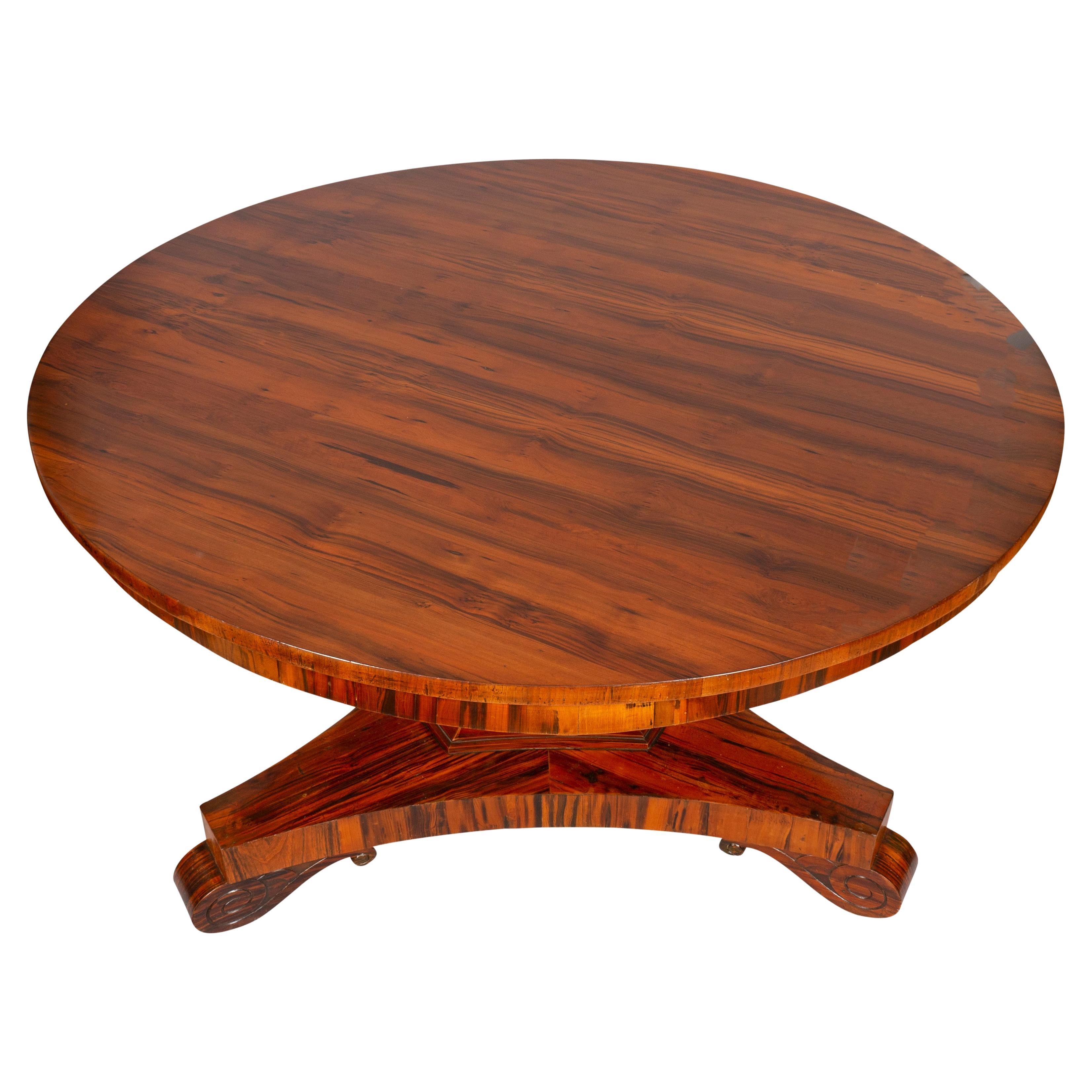 Circular hinged top with vibrant pattern and matching shallow apron raised on a triangular support and ending on a tripartite base with Vitruvian scroll feet. Goncalo Alves is a wood from Brazil favored for it contrasting streaks of color.