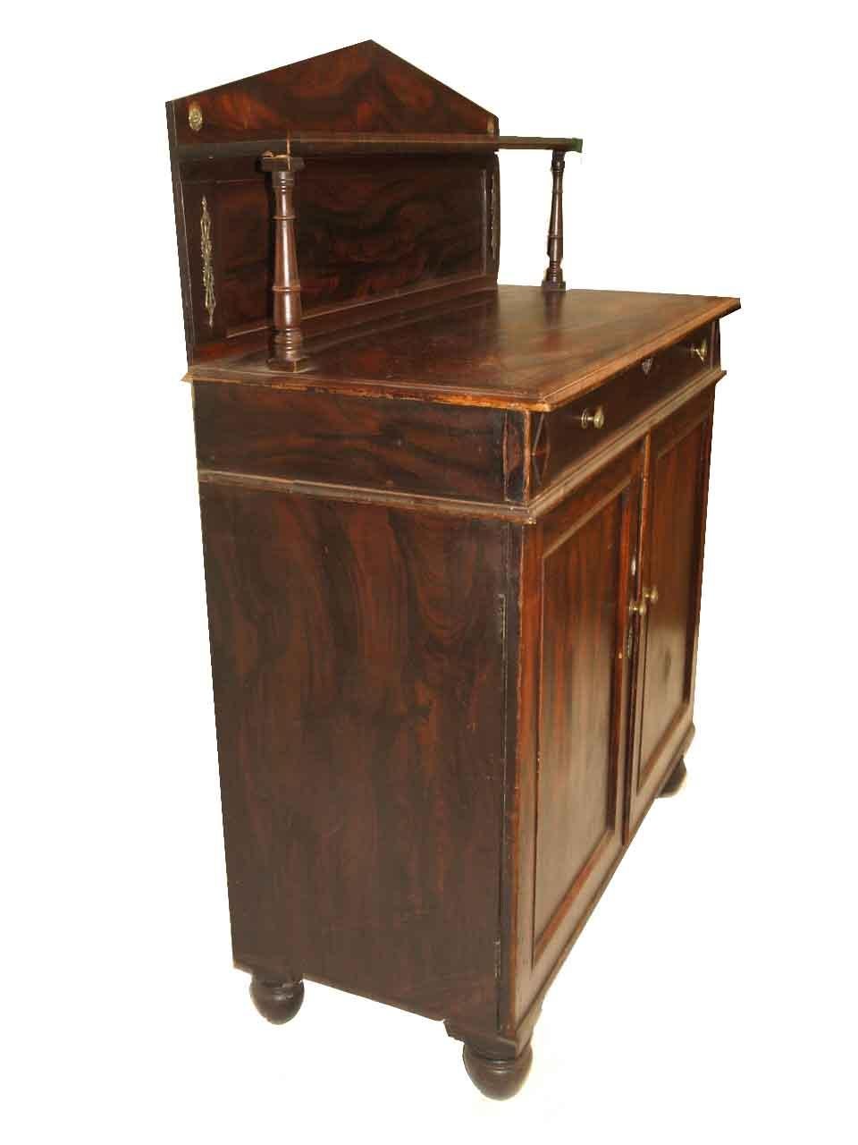 Regency grain painted cabinet, with all over faux bois painting that is designed to simulate rosewood. The arched back has a narrow shelf supported by turned columns (note the brass rosettes and ornate brass appliques at each end). The top with