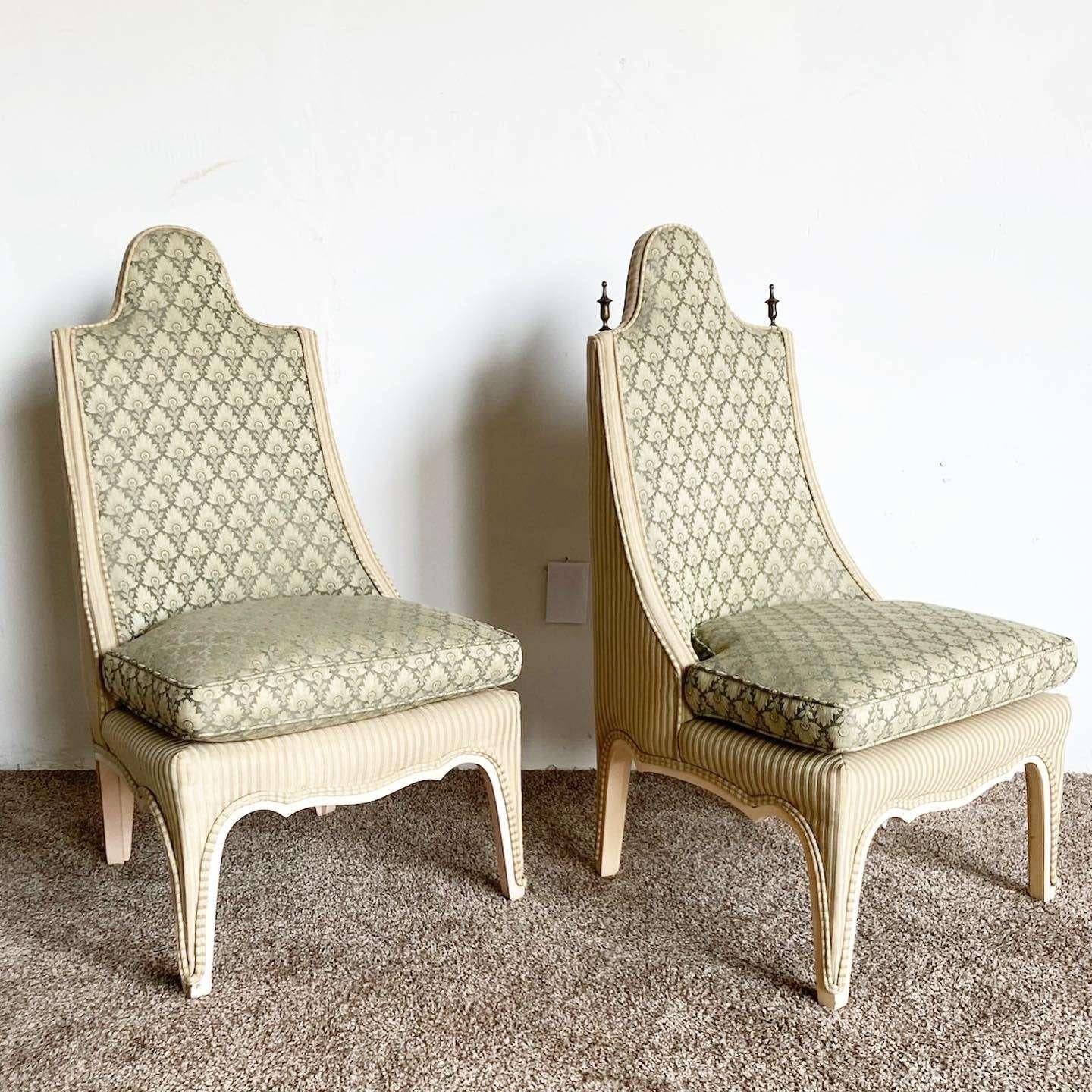 Amazing vintage regency pair of accent chairs. Each feature a green upholstery with a sculpted frame.
