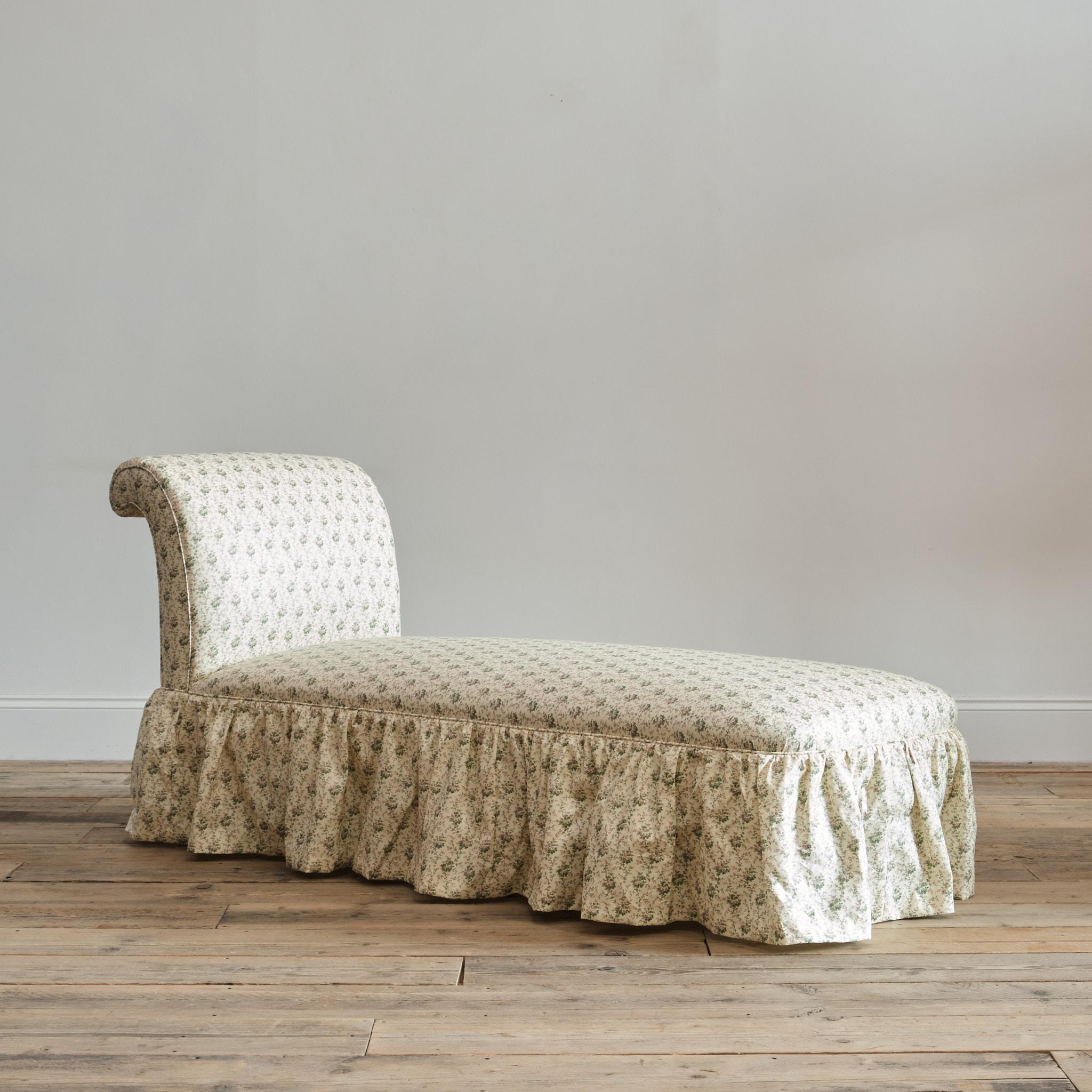 An English Regency daybed by Holland & Sons - London. Newly upholstered by us in Rambling Rose from Howe at 36 Bourne Street - London. Raised on 4 thick turned legs with the original Gilt Brass Casters. 

43cm seat height

147cm seat length