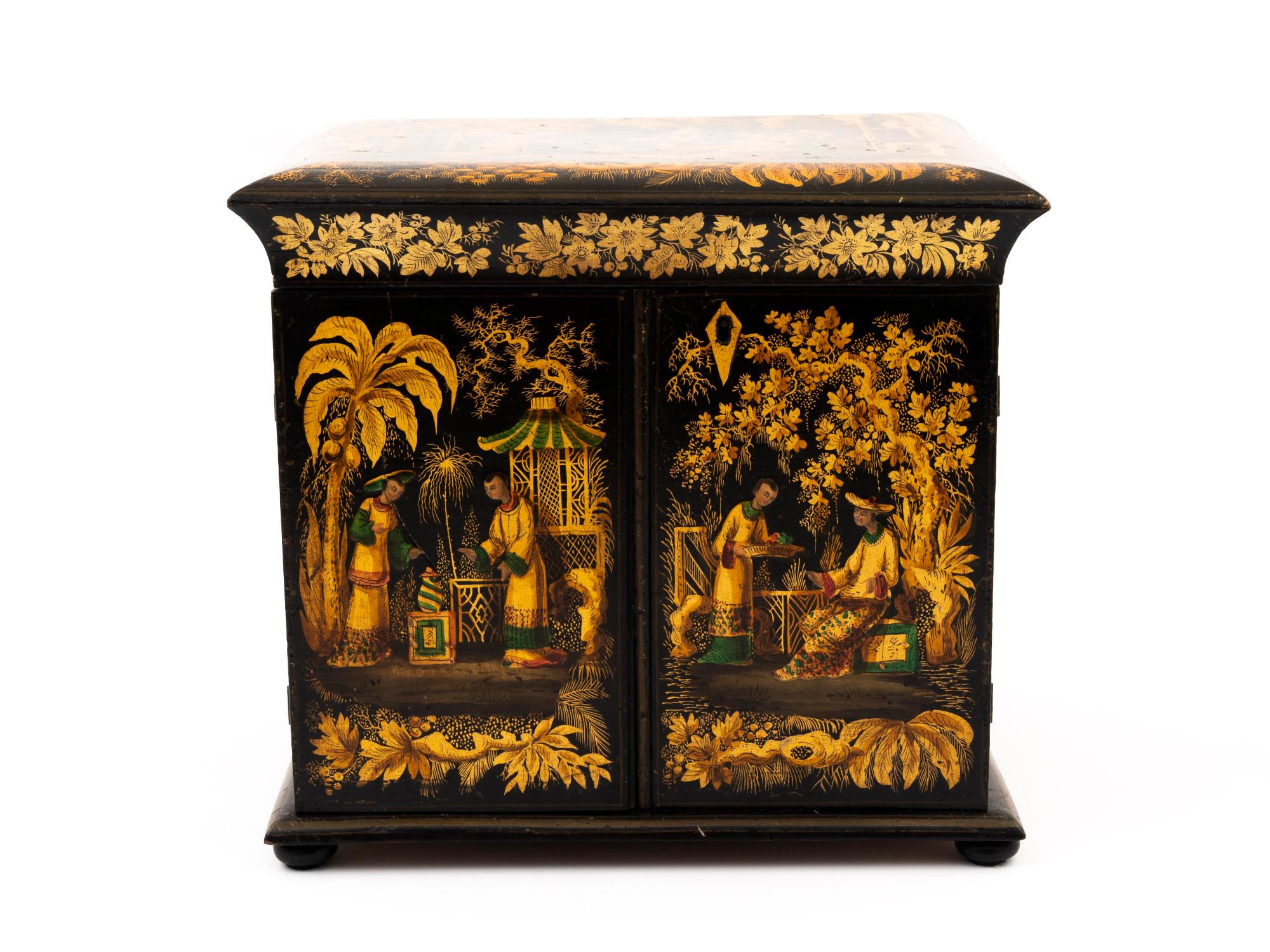 Regency Japanned sewing cabinet beautifully decorated with vibrant chinoiserie scenes.

The front and top of the Japanned table cabinet has detailed paintings of figures surrounded by beautiful garden scenes, while the sides have more simplistic