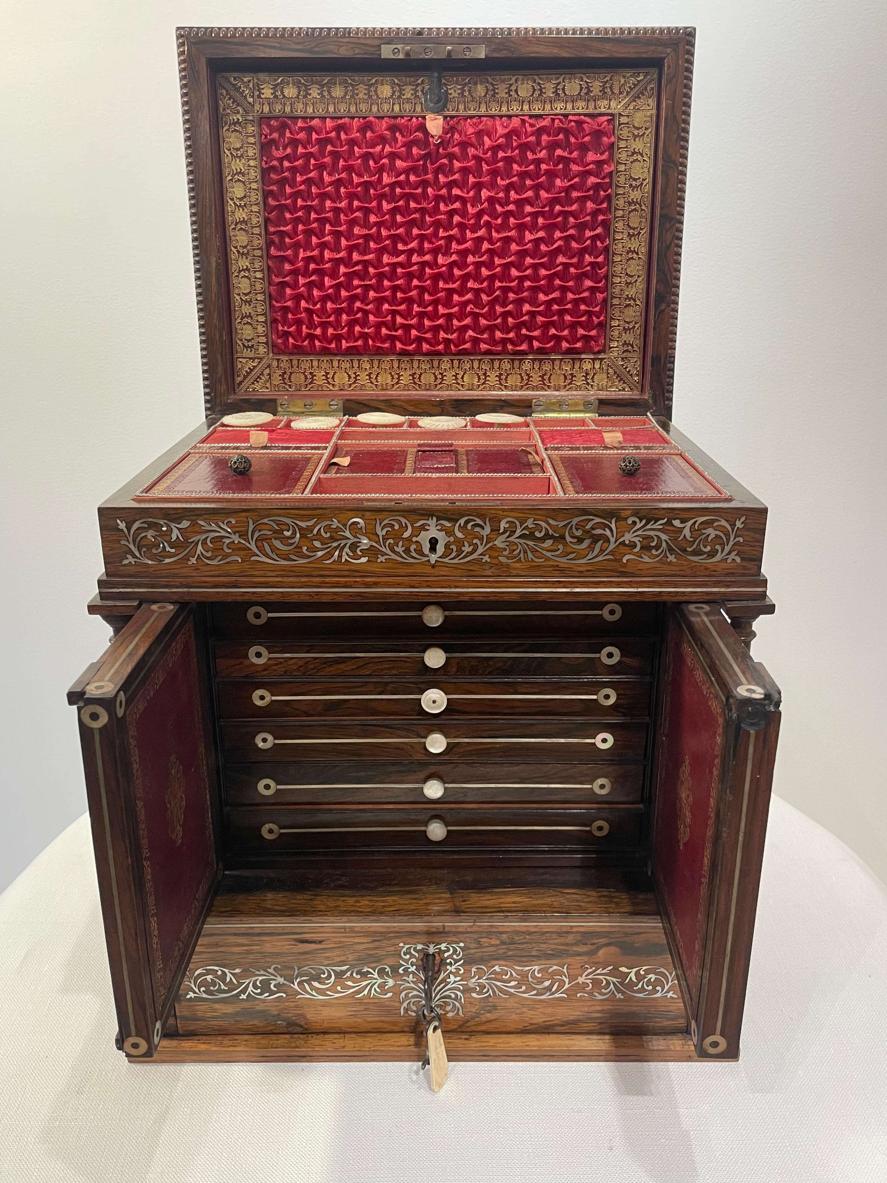 A William IV classical work box in walnut with mother-of-pearl inlay detail. Of classical form in the shape of a Grecian temple, the workbox comes from the collection of Ann Margaret and includes various original components to the interior. 