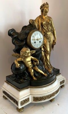 Grande horloge de style Régence en marbre doré, bronze patiné et bronze doré représentant une jeune fille chérubin