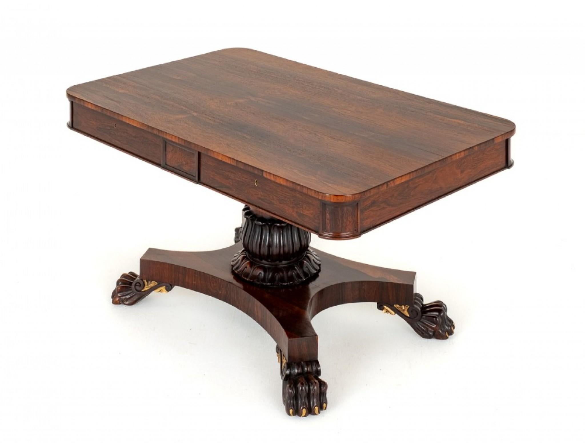 Regency Rosewood Library Table.
This Library Table Stands Upon a Platform Base with Boldly Carved Lions Paw Feet.
The Column Being of a Carved Form.
Period Regency
The Table Features 4 Mahogany Lined Drawers.
The Top of the Table Having Matched Rio
