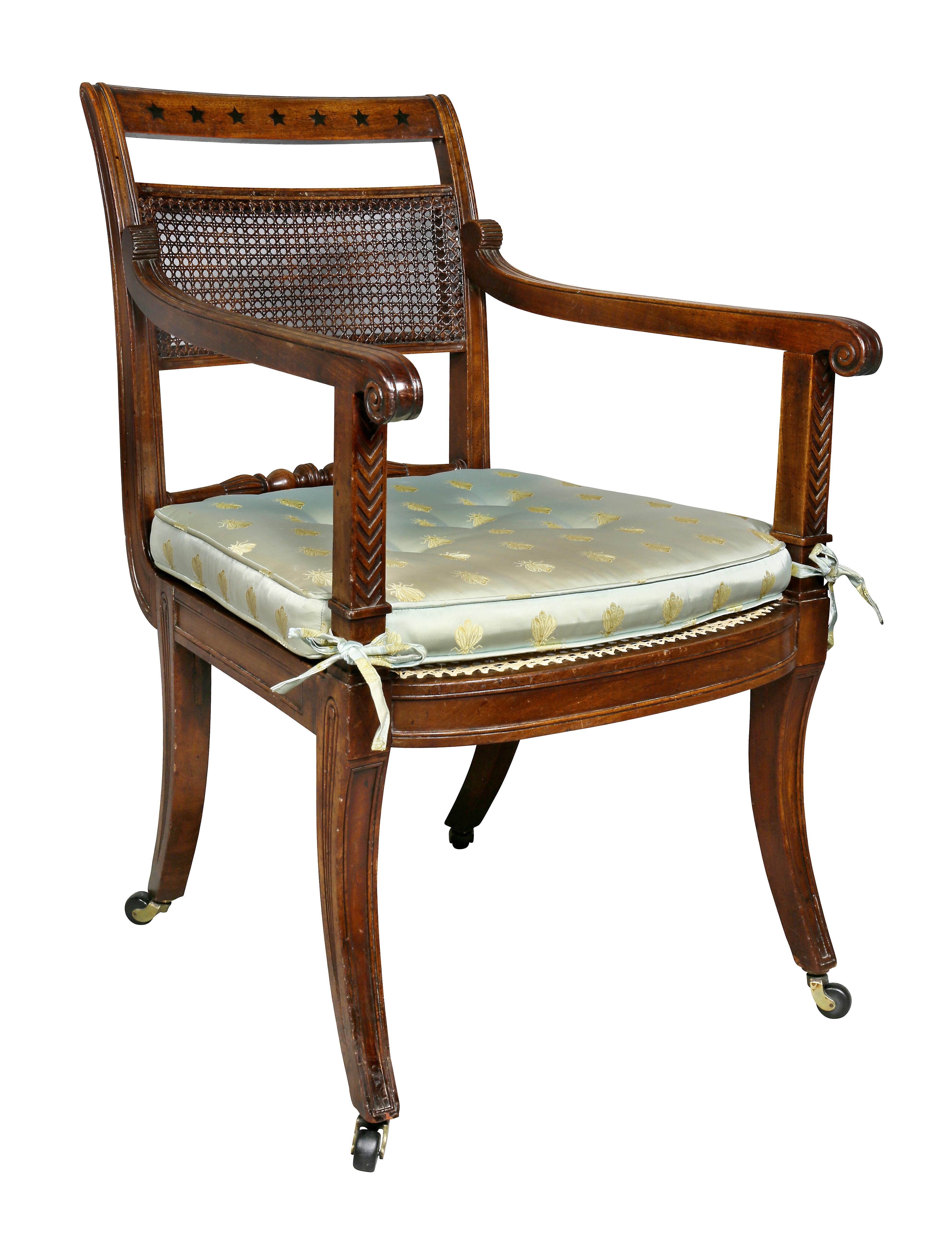 Very elegant chair with a tablet crestrail with star inlay , carved arms, caned back and seat , saber legs. Cushions available. Newly caned seat, would make a great desk chair. Provenance; Hyde Park Antiques.