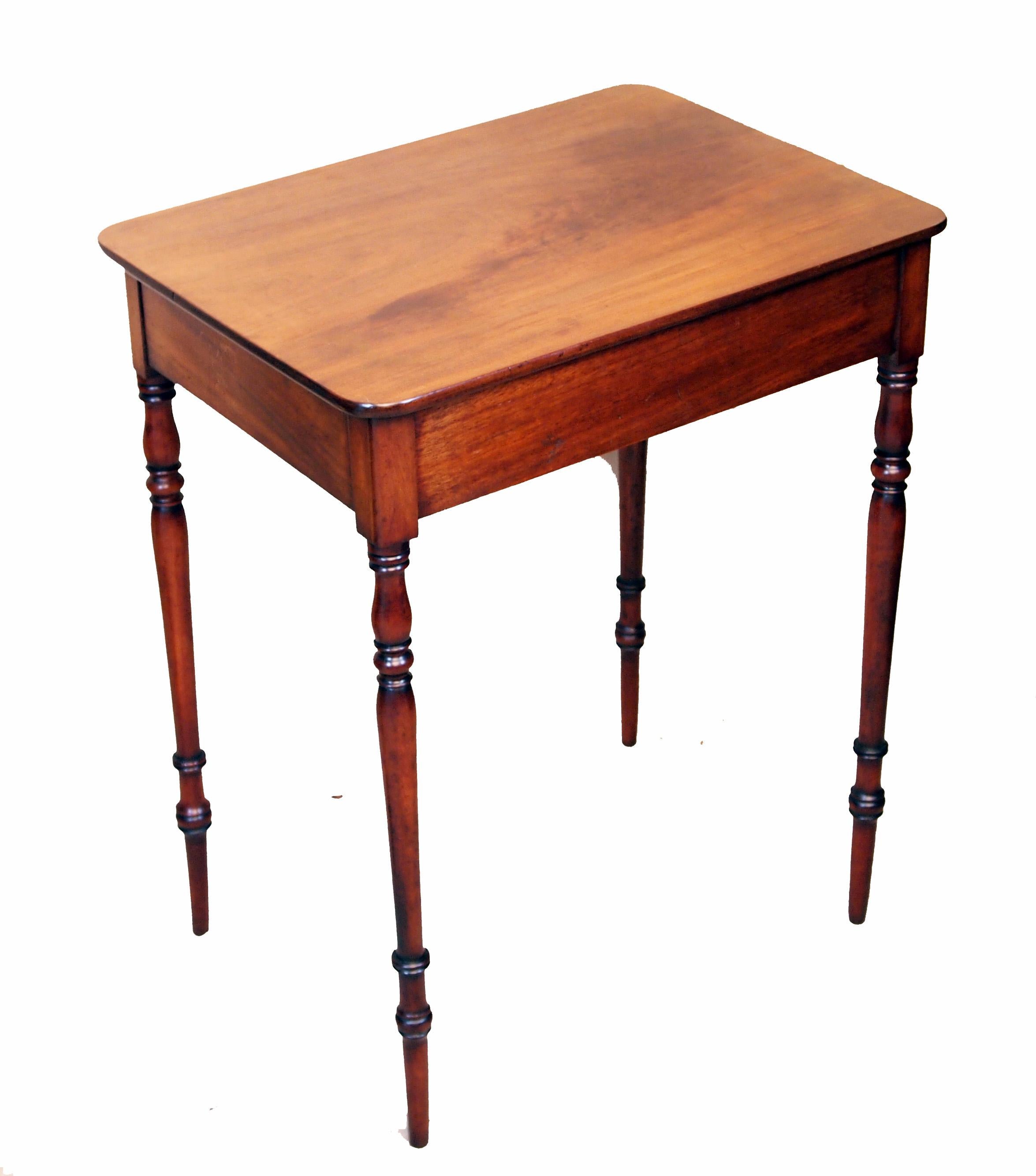 A very attractive Regency period mahogany side table of
diminutive proportions having well figured top above one frieze
drawer with original turned wooden knobs and ebonised
decoration raised on elegant turned legs

(This little Regency table
