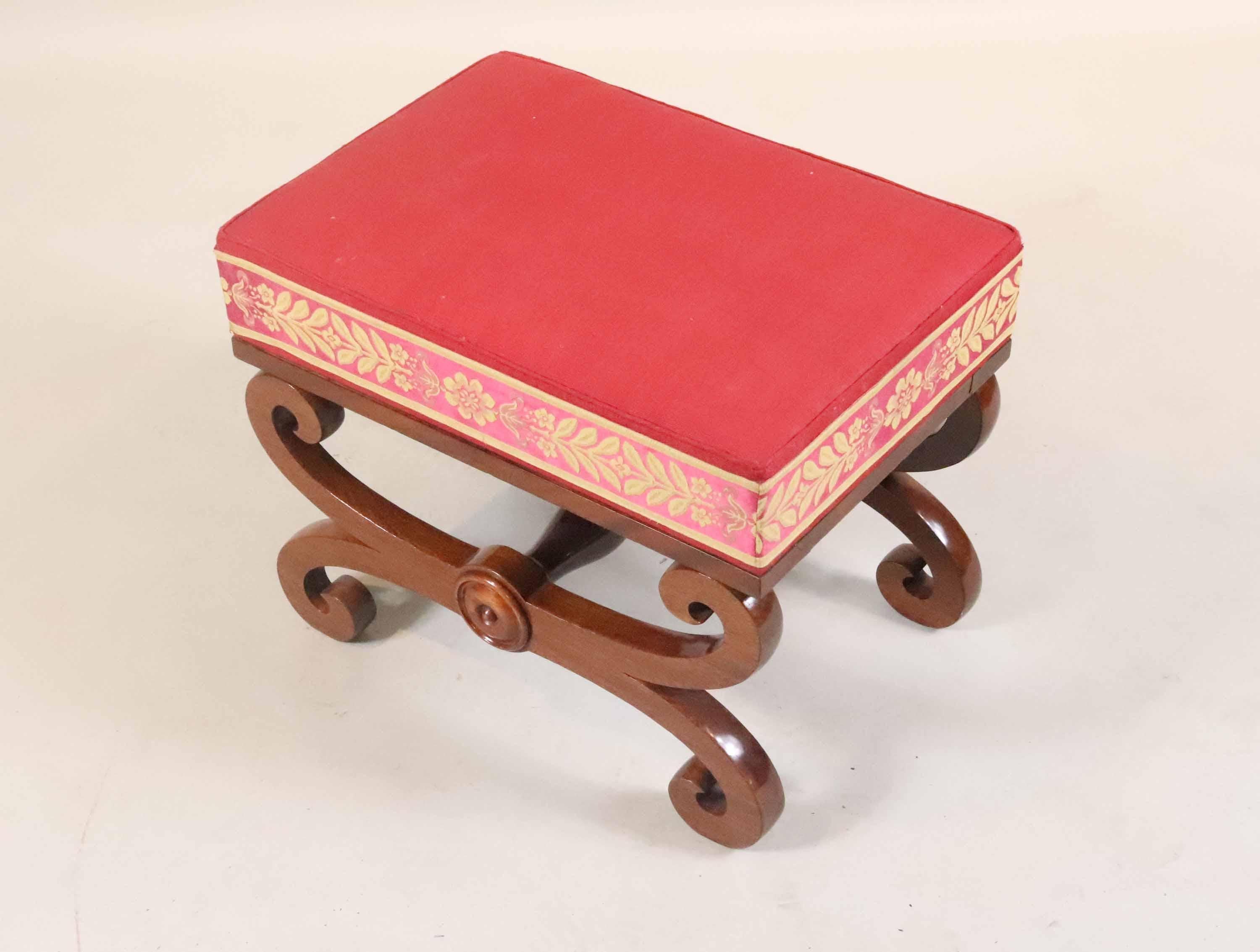 An upholstered Regency bench or stool, in mahogany, with scroll form frame and nicely upholstered cushion seat, early to mid 19th century, English.