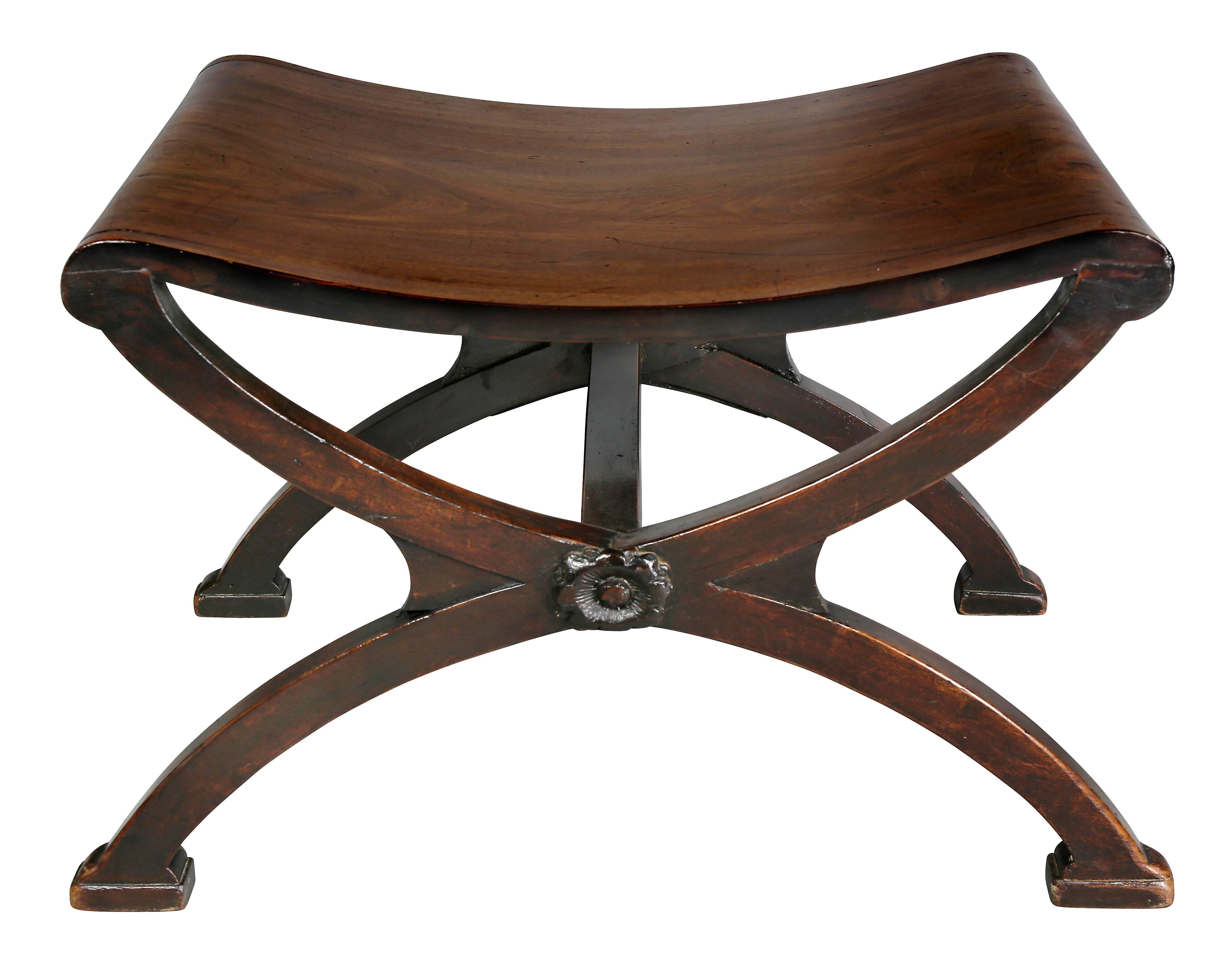 With rectangular wood saddle seat raised on X-form supports joined by square stretcher with rosette.