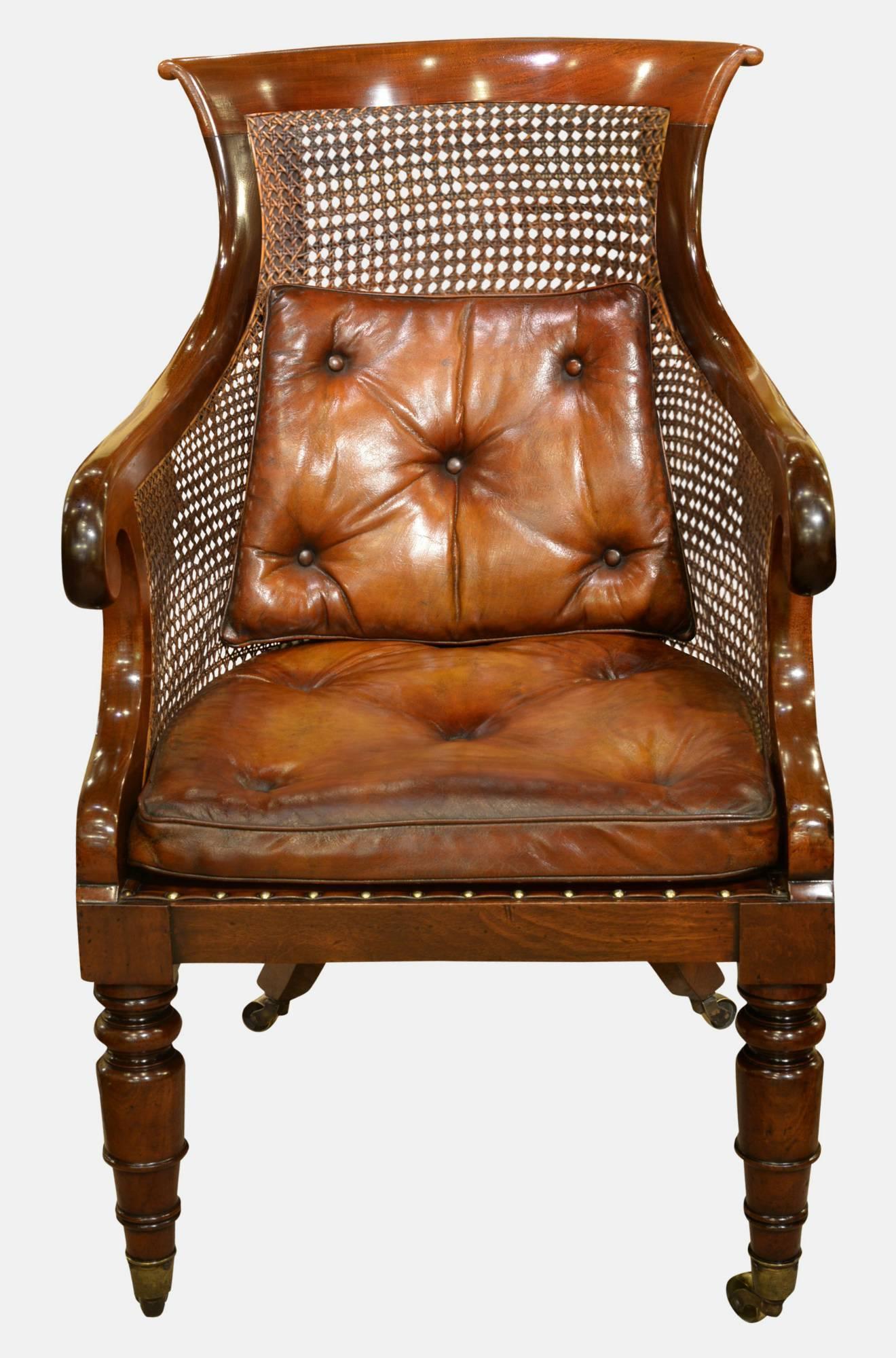 Regency mahogany bergère library chair of good large proportion. With buttoned hide cushions and seat height of 19