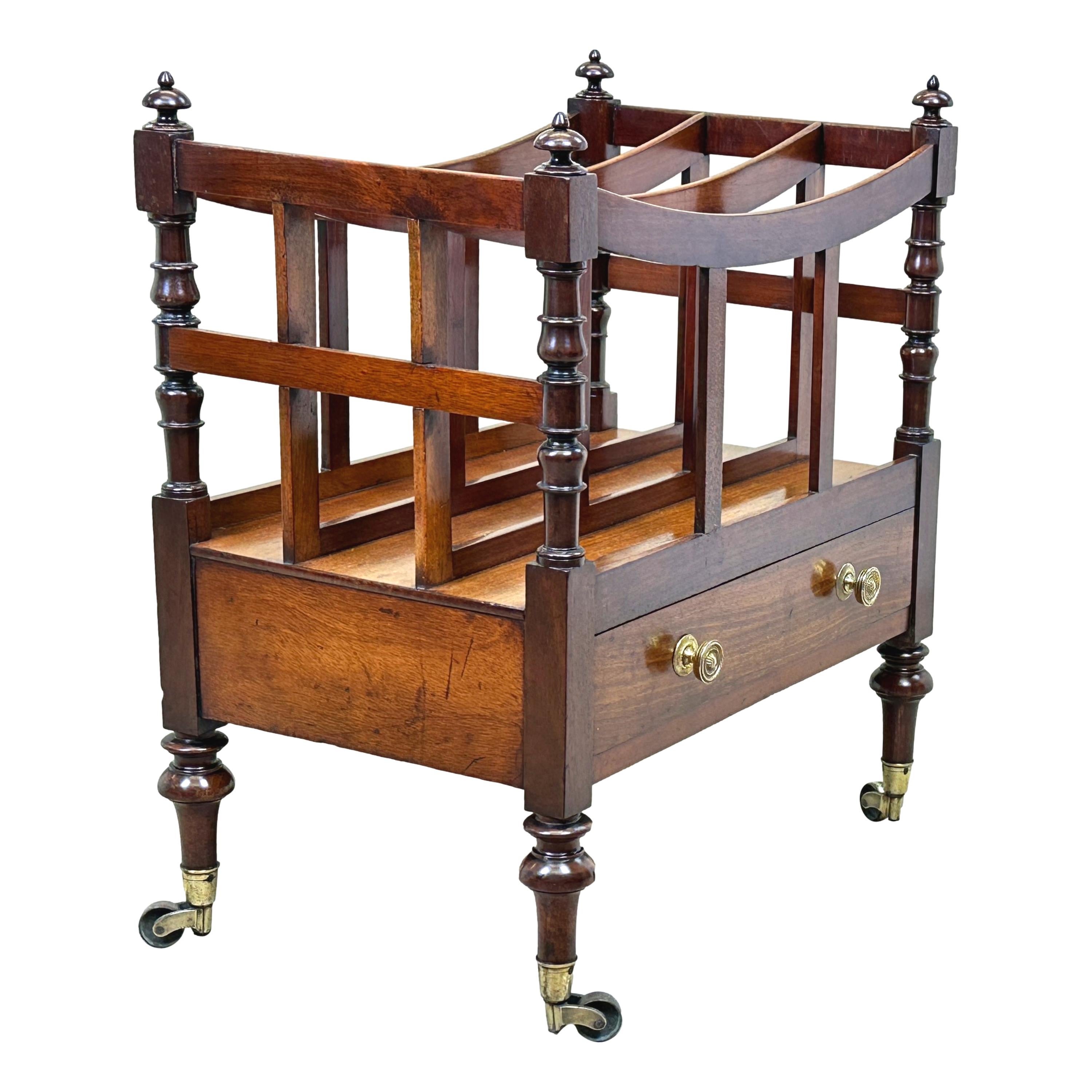 An Exceptional Quality Regency Period, Early 19th Century Mahogany Boat Shaped Canterbury Having Elegant Turned Upright Supports And One Drawer To Frieze, Raised On Tall, Tapering, Turned Legs With Original Brass Castors.

Label To Drawer - 