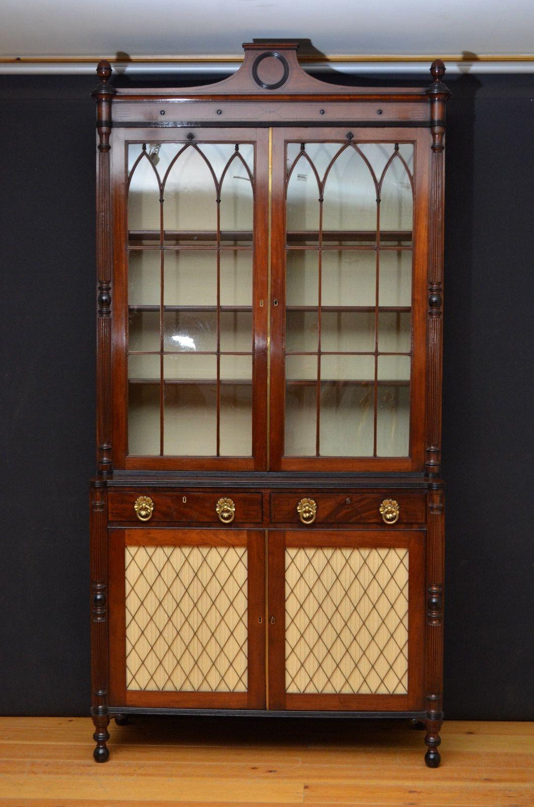 Sn4543 A large Regency bookcase in mahogany, having architectural pediment above string inlaid flamed mahogany frieze and a pair of astragal glazed doors enclosing 8 height adjustable shelves and fitted with original working lock and a key, all