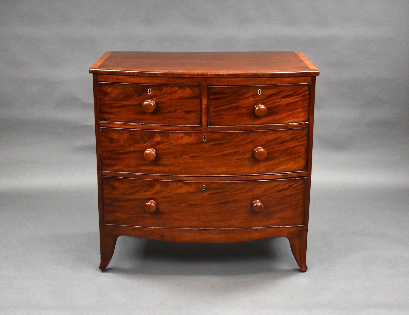 For sale is a Regency mahogany bow front chest of drawers, having a banded top above an arrangement of two short over two long drawers, each having well figured drawer fronts with bun handles. The chest is raised on splayed feet and is in good