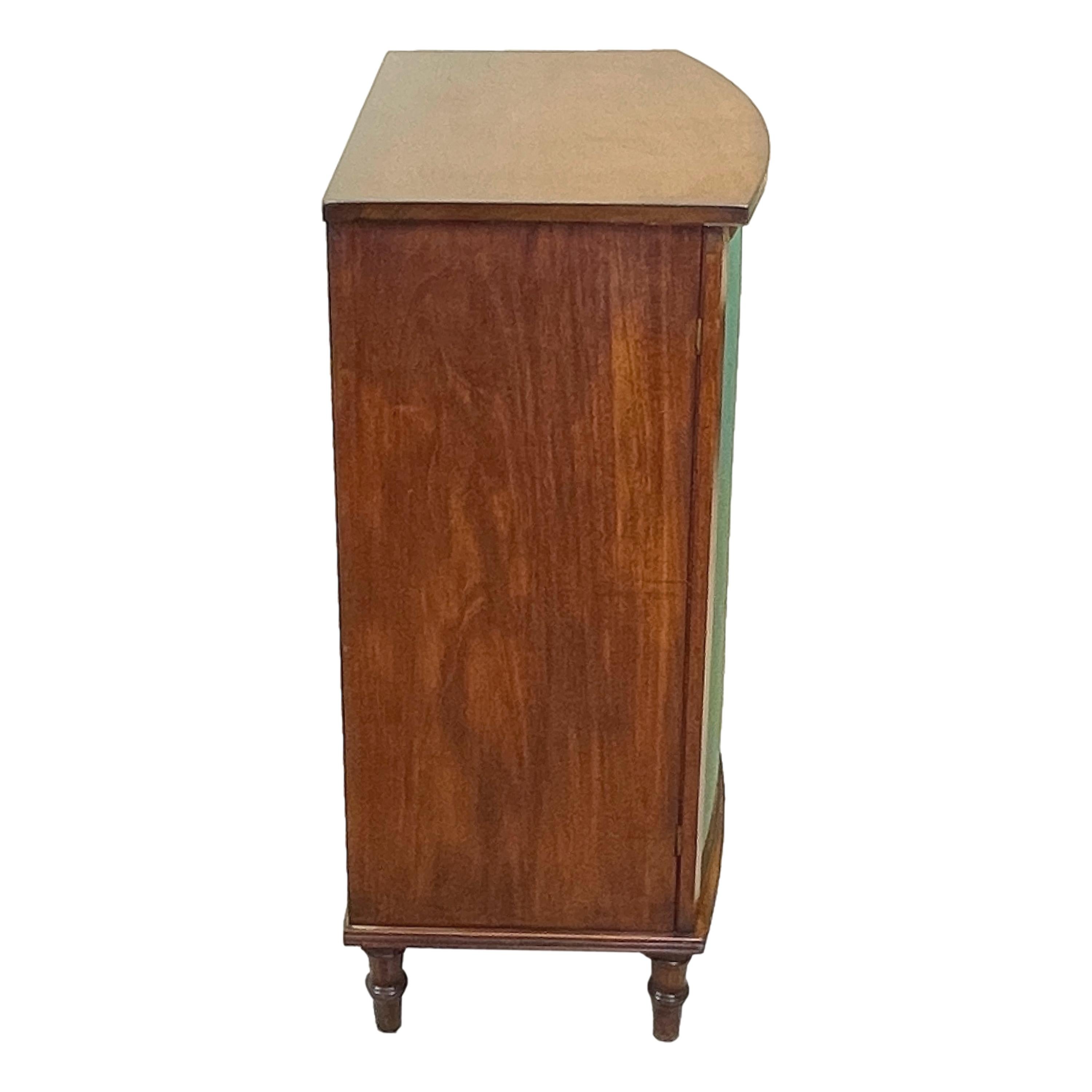 A good quality Regency period mahogany bowfronted
Side cabinet, or side cupboard, having well figured top
Over two silk panelled doors enclosing interior shelves
Raised on elegant turned tapering feet

(Both elegant and functional this side