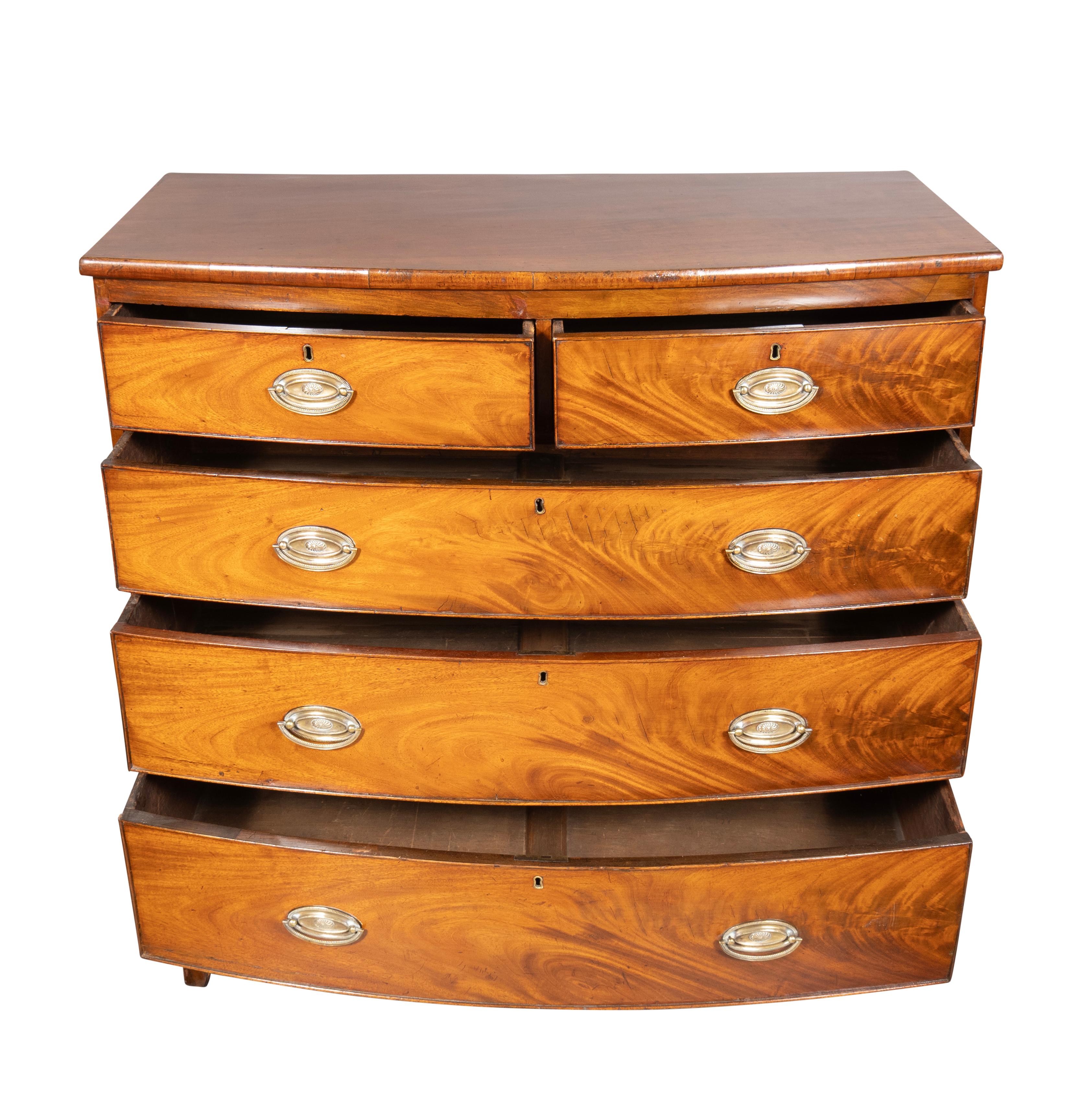 Rectangular with a bowed front containing two short over three long drawers. Oval brasses and ending on splayed feet.