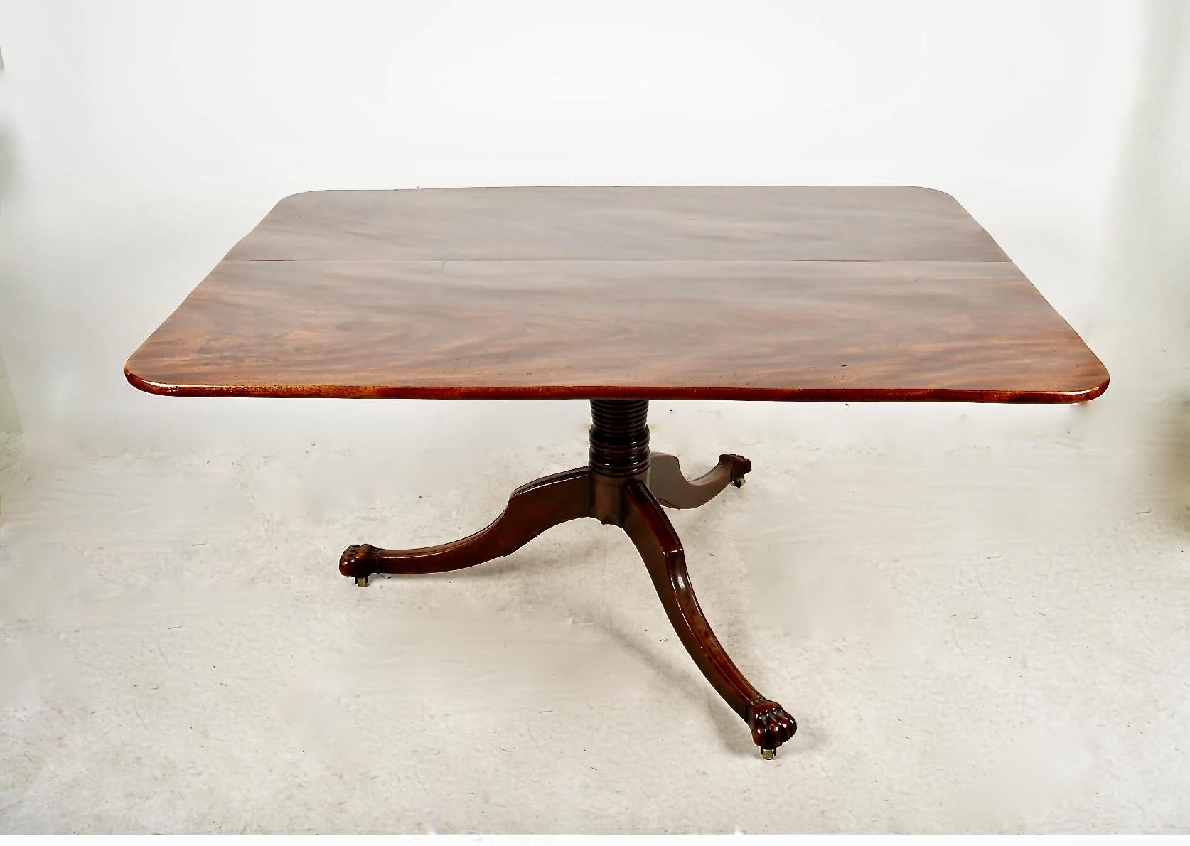 This is a large English Regency tilt-top breakfast table. The two board solid mahogany top is well-grained and in overall very good condition, retaining an old, but not original, surface. The top has acquired a rich natural patina; there are couple