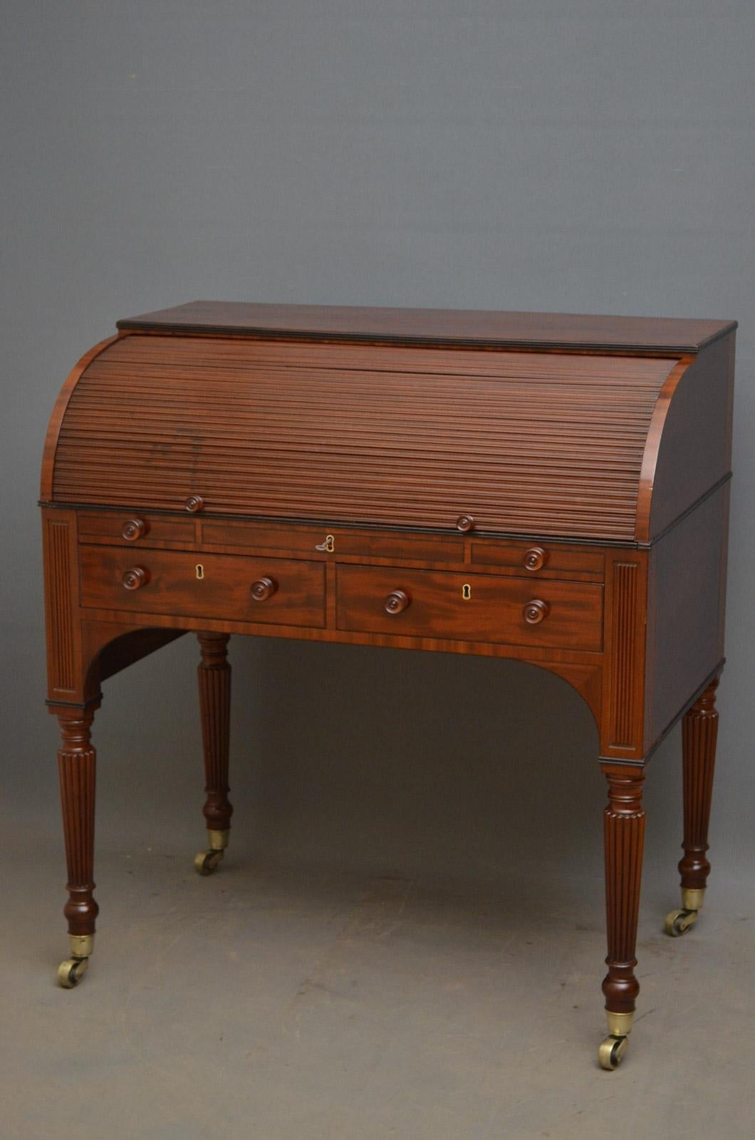 Sn4593, fine quality and very unusual, Regency, mahogany writing desk /bureau, having tambour top enclosing satinwood and string drawers, pigeon holes and adjustable writing surface in black tooled leather, above 2 mahogany lined drawers flanked by