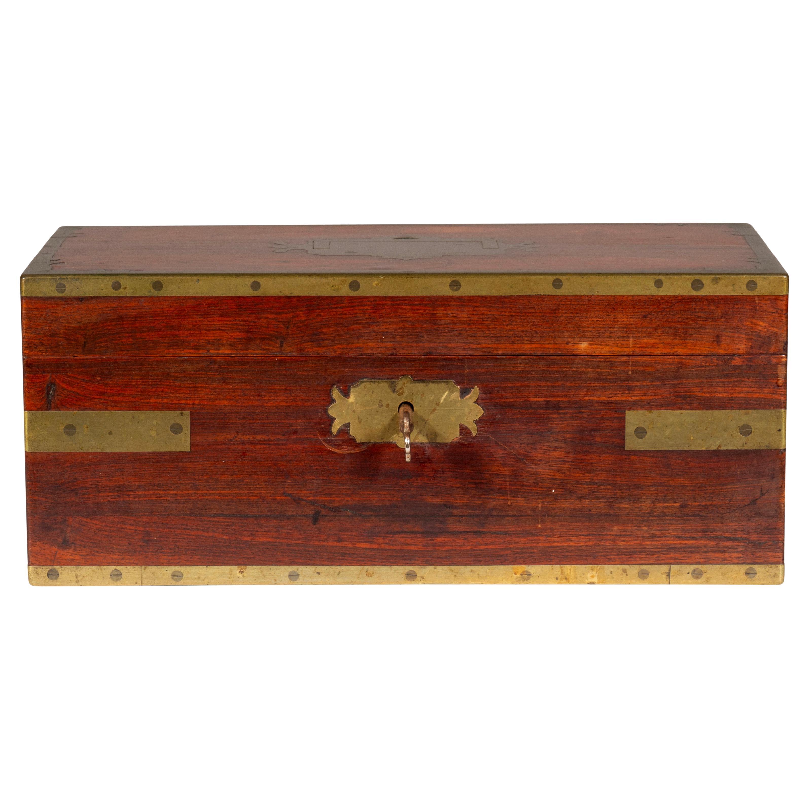 Finely made with brass banding. Interior with original red leather fittings. Labelled Bayley & Blew , Cockspur Street, London. Manufactures. Probably for an officers valuables. With key.