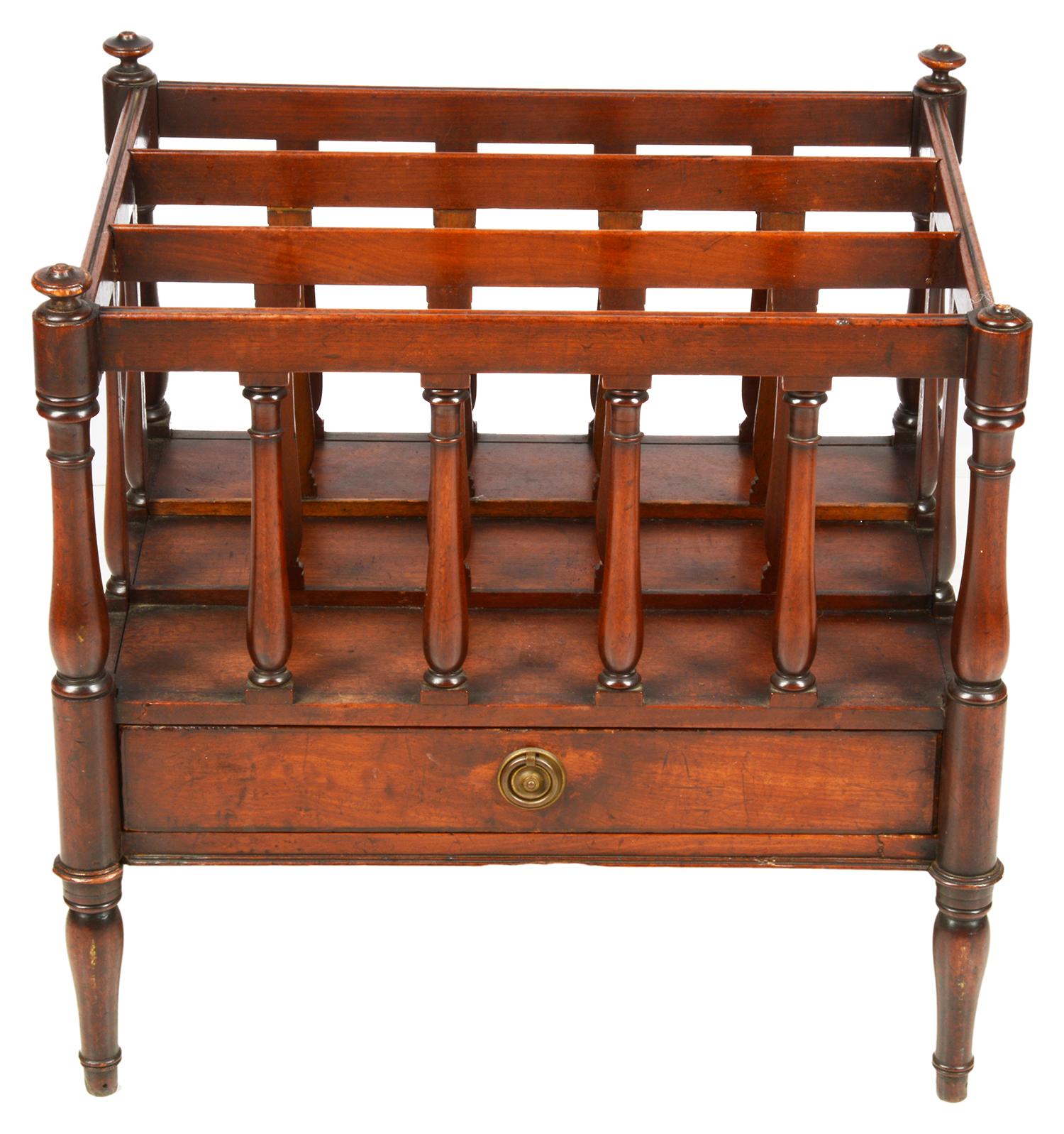 A good quality Regency period mahogany Canterbury, having three slatted divisions with ring turned supports, a single frieze oak lined drawer and raised on turned tapering legs.