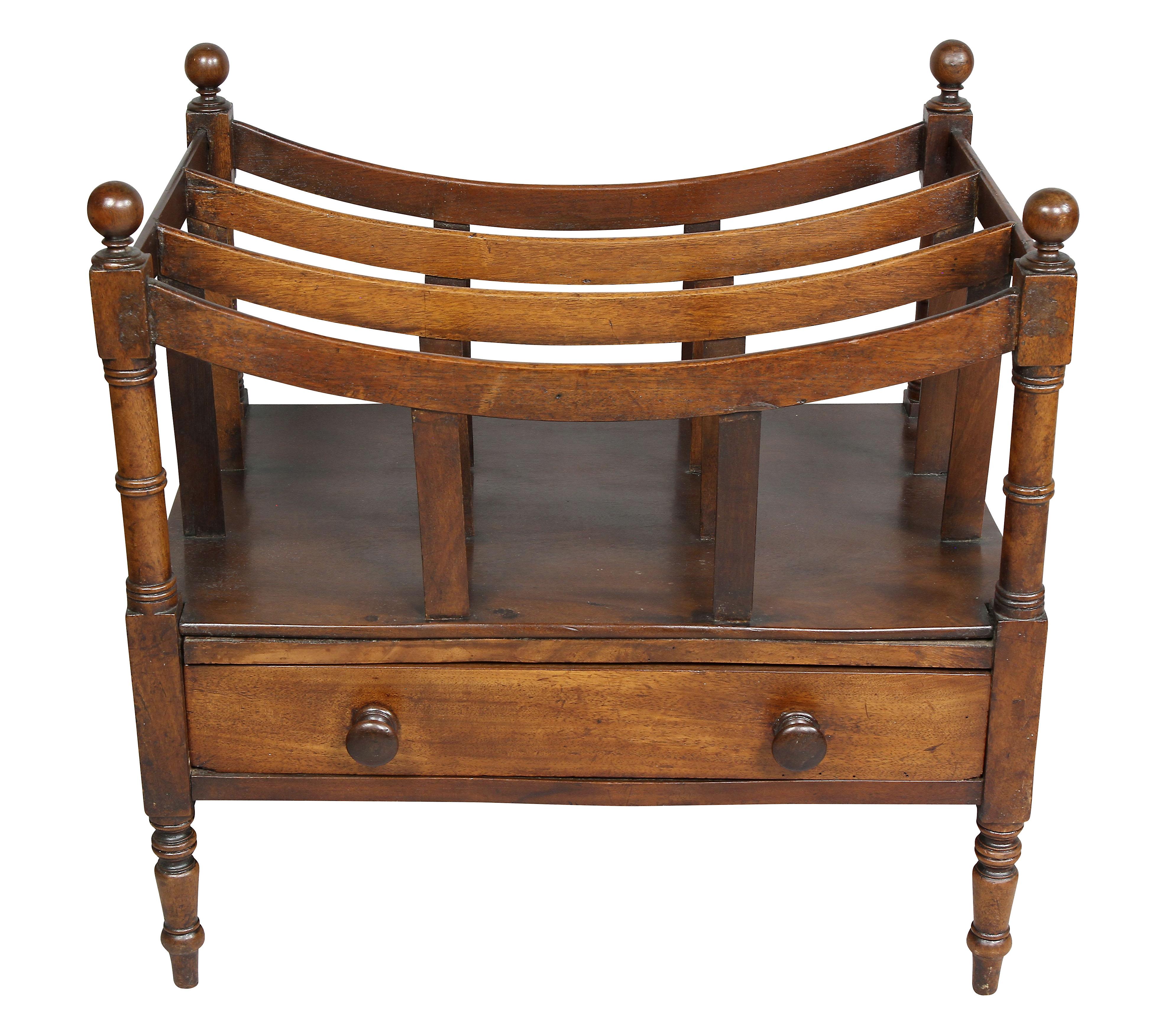 Orb finials and three compartment slats over a drawer with wood knobs, raised on turned legs.
