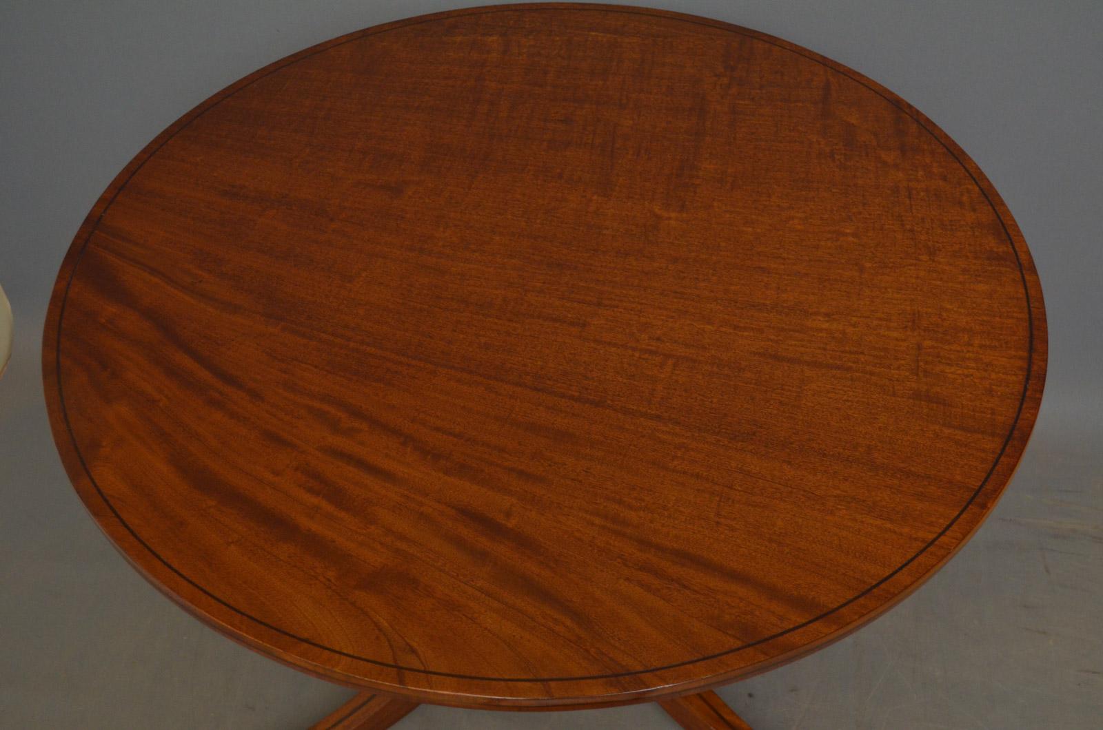 Sn4501, fine quality Regency mahogany dining table or centre table, having figured mahogany top with string inlaid edge and turned, ringed and ebonised column terminating in 2 downswept string inlaid legs and original brass paw feet castors. This