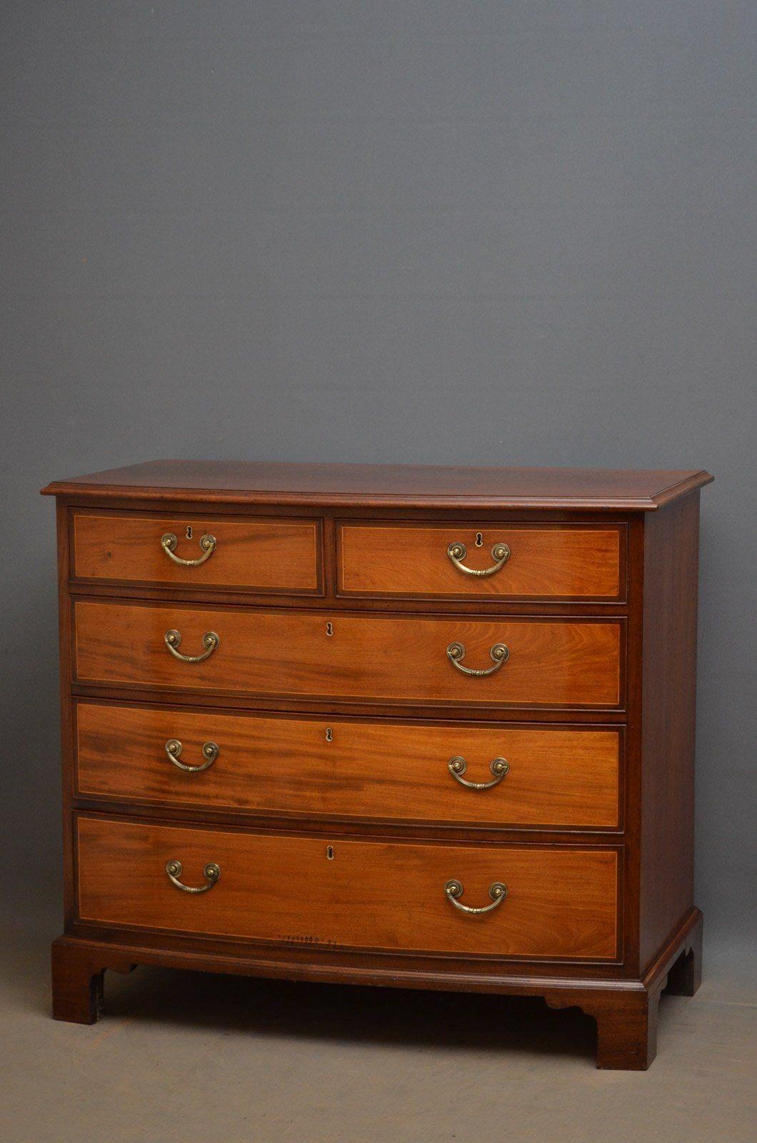 Sn3976 Regency bow fronted chest of generous proportions, having figured top above 2 short and 3 long cockbeaded, string inlaid and oak lined drawers, all fitted with original brass handles, standing on original bracket feet. This antique chest of
