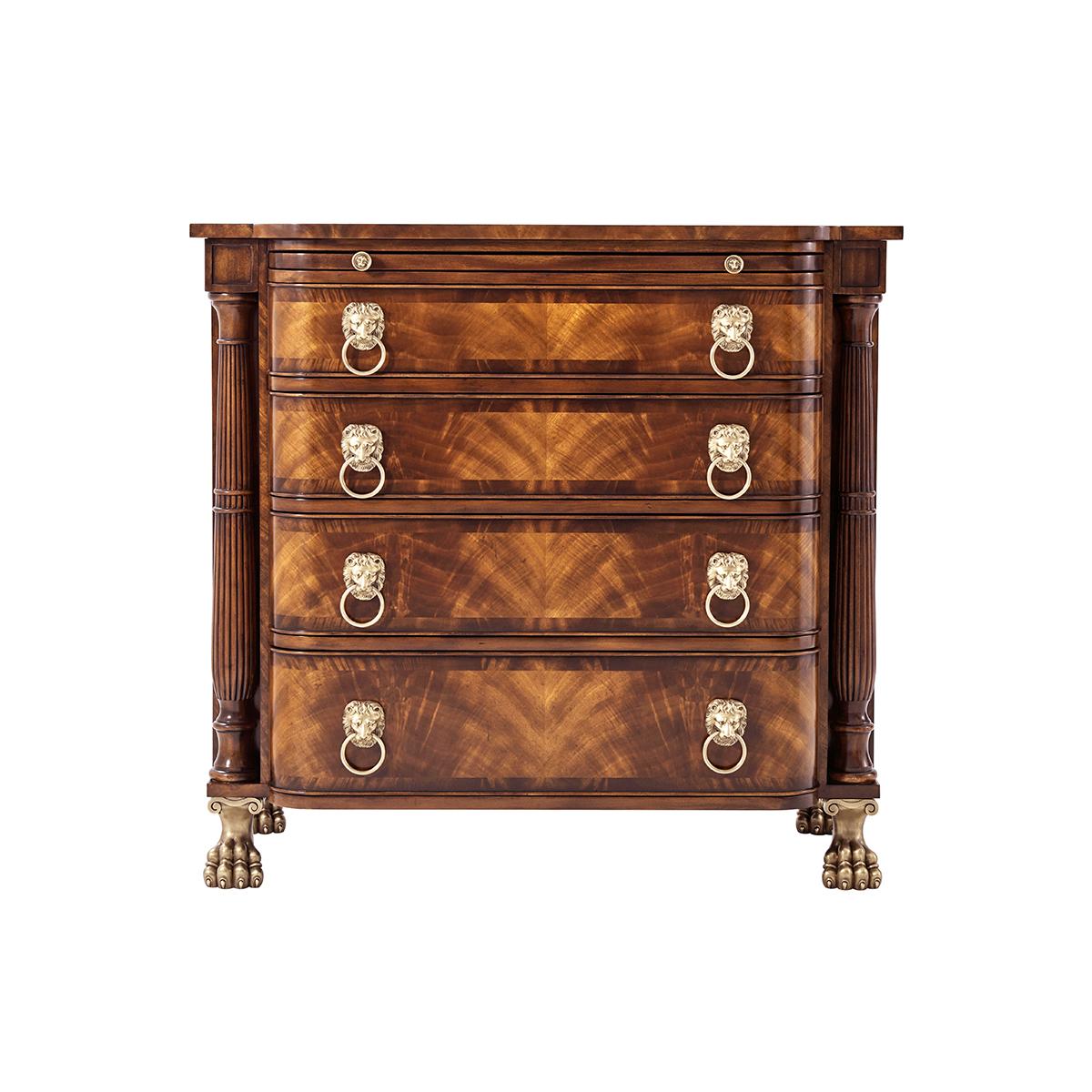 A Regency style mahogany and flame veneered bowfront chest of drawers, fitted with a brushing slide and four graduated rounded drawers fitted with lion’s mask drop handles flanked by reeded and bound column uprights on brass lion’s paw