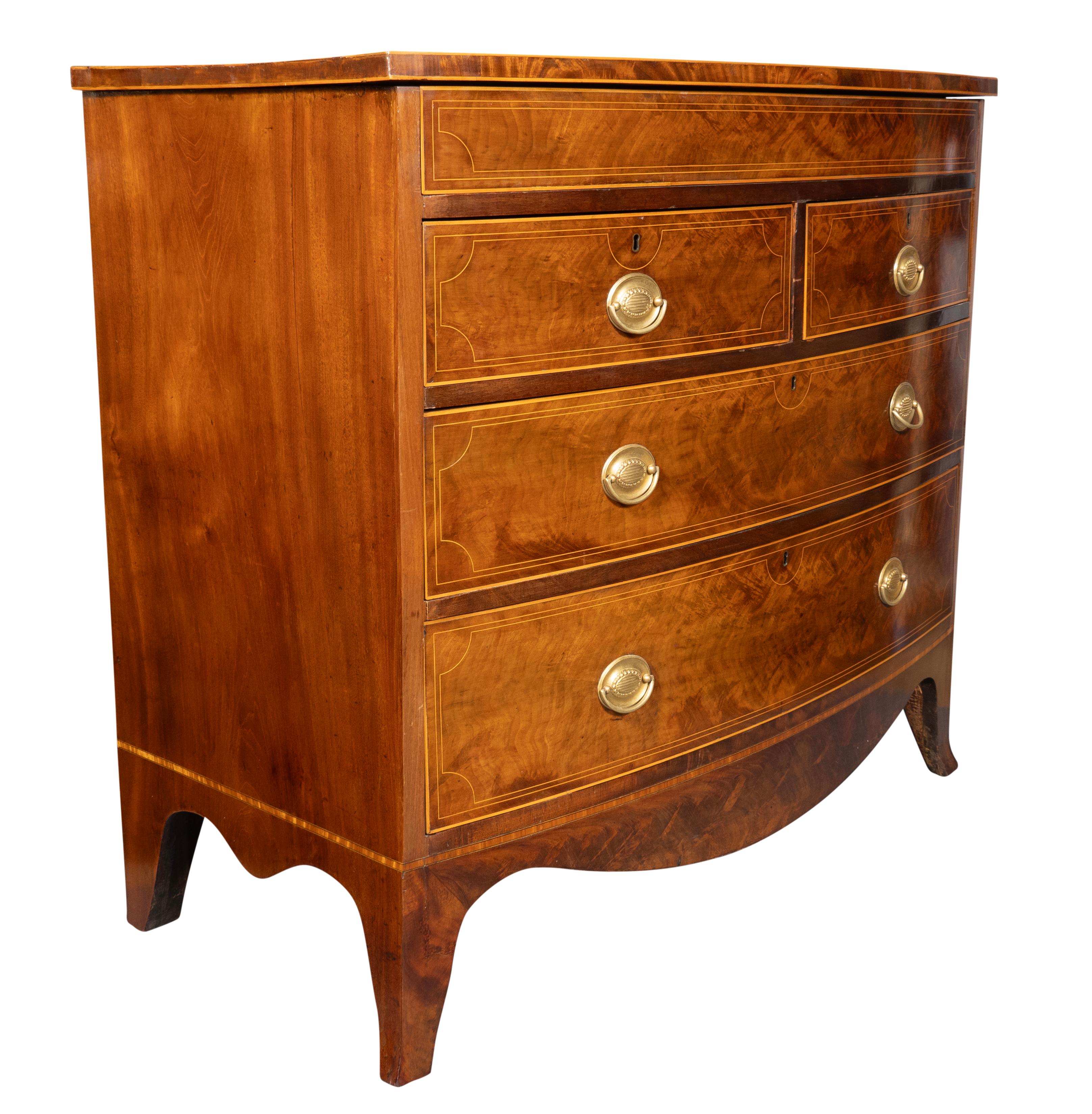 With rectangular bowed top with string inlay over five functioning conforming graduated drawers , the first a drawer with no handles that acts as a secret drawer and can be opened when either of  the next pair of drawers down is opened. Two long