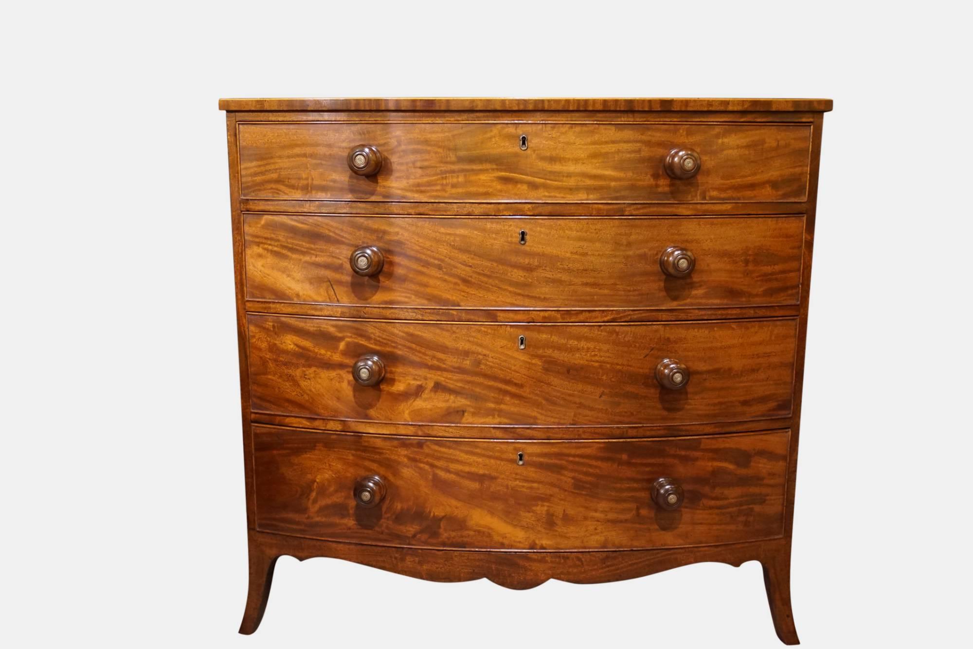 A Regency mahogany chest of four Graduated drawers of fine figure and colour raised on elegant splay feet, original knot handles,

circa 1810.